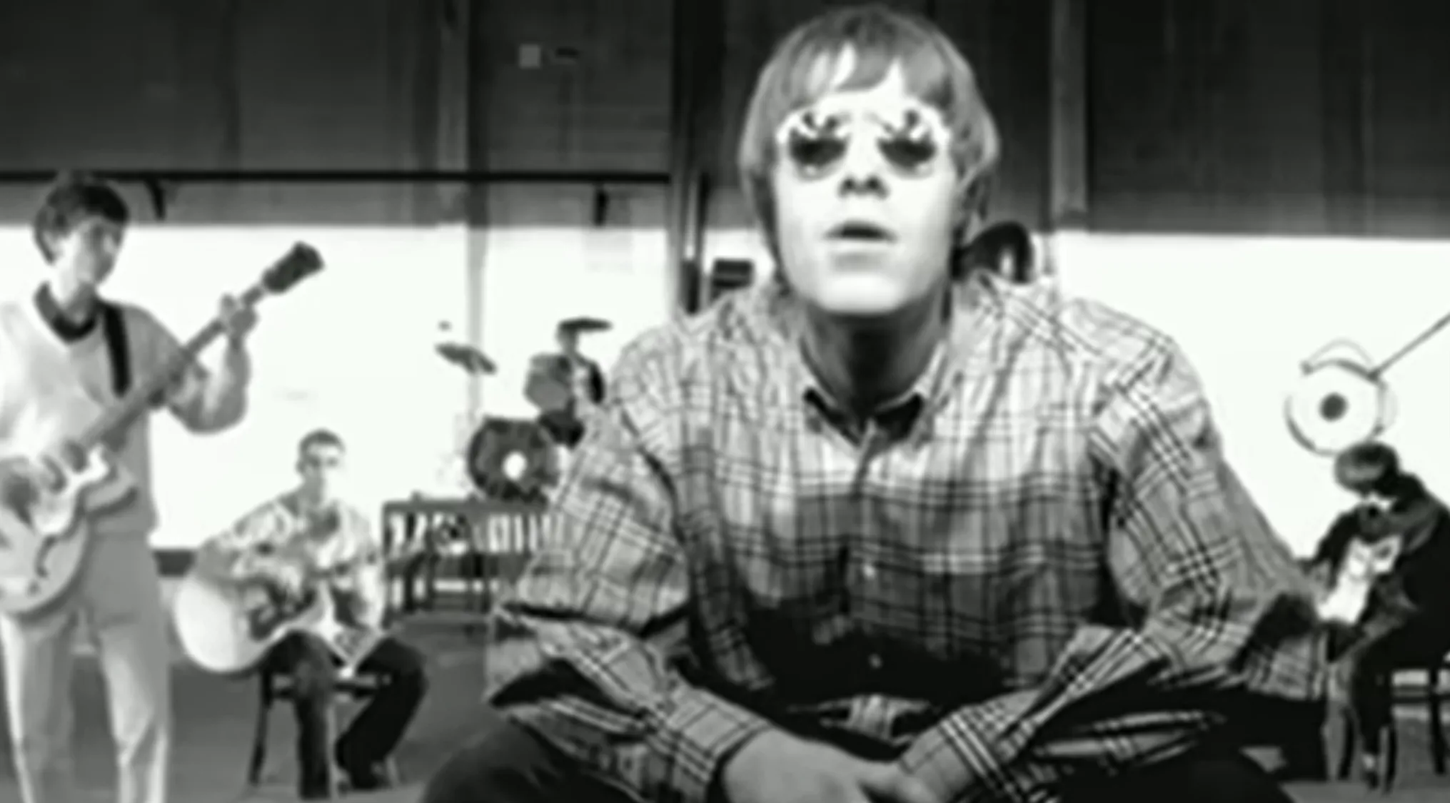 English band Oasis performing Wonderwall, with Liam Gallagher in the foreground.