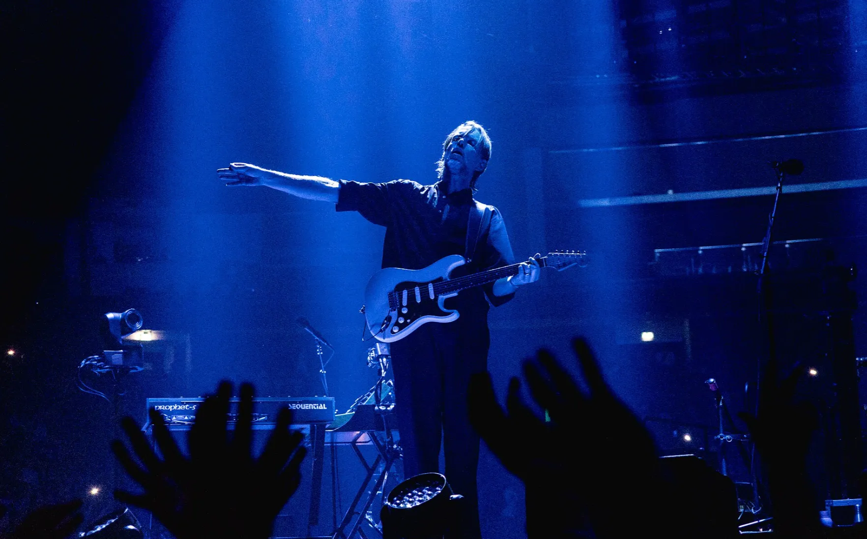 Radiohead's guitarist performing live on stage, 80s-90s music from A to Z.