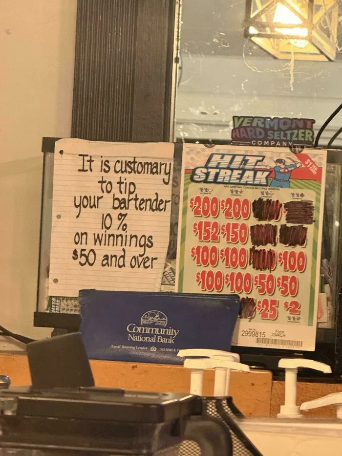 A handwritten sign advises to end tipping culture, requesting 10% on winnings $50 and over.