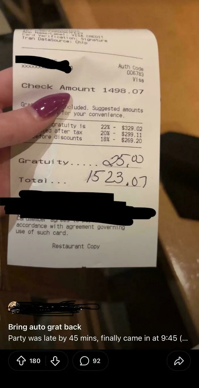 A restaurant receipt showing a large bill with suggested gratuity and a written-in tip, representing tipping culture.