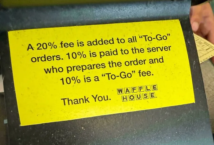 A Waffle House sign explaining a 20% fee for To-Go orders, breaking down tipping culture.
