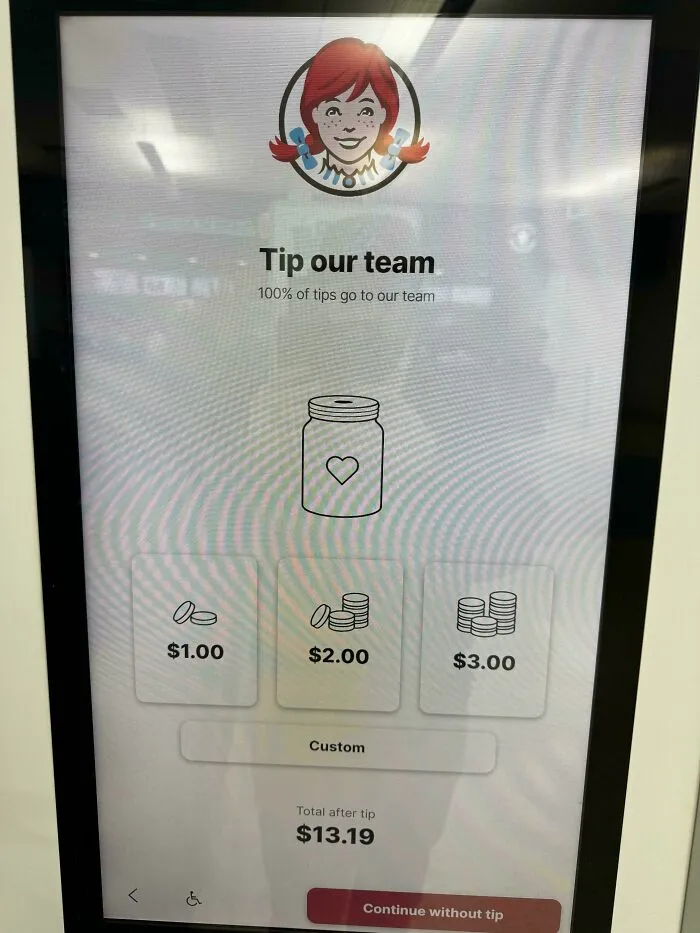 A digital screen for Wendy's, prompting customers to tip the team with options for $1, $2, $3. End tipping culture.