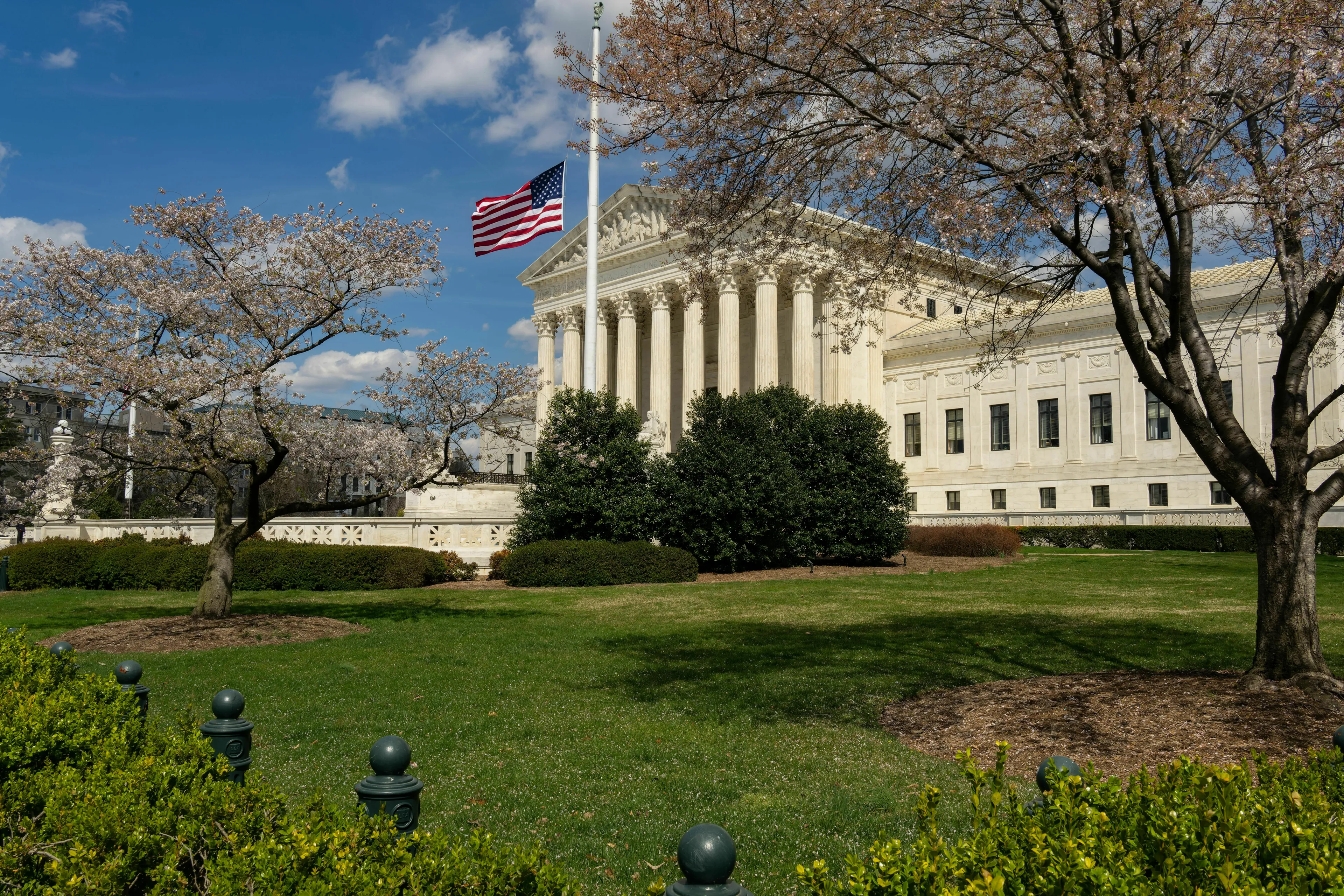 The Supreme Court building with an American flag, symbolizing a key case in Government & Politics.