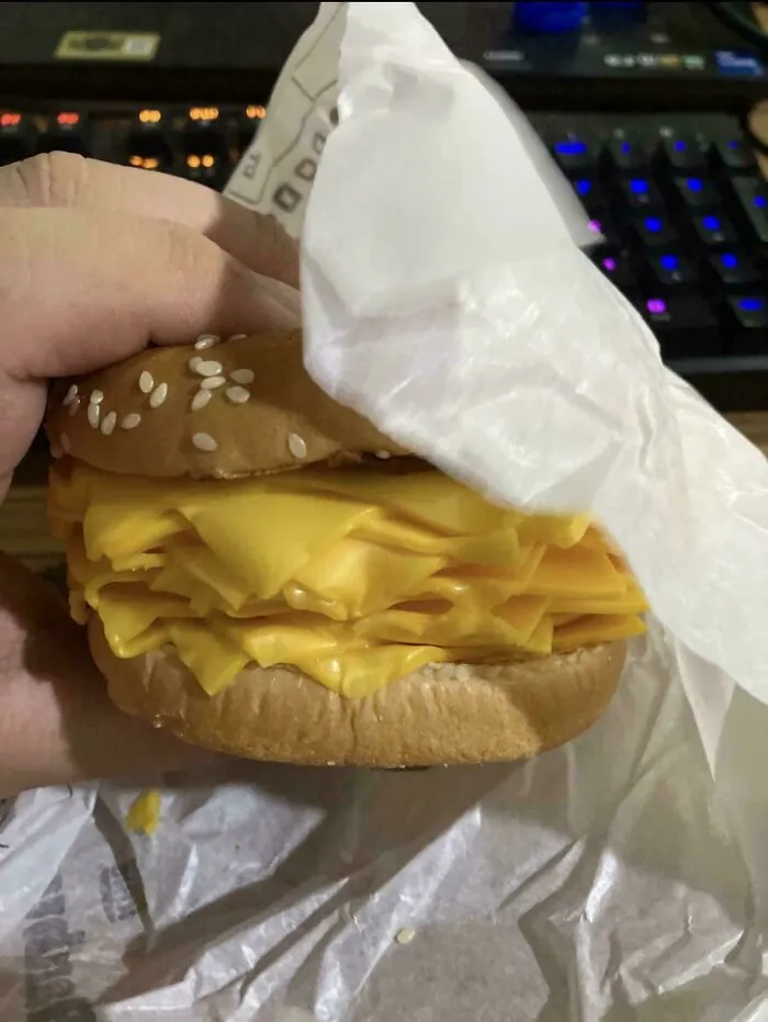 A burger filled only with dozens of slices of yellow cheese, a questionable food combo.