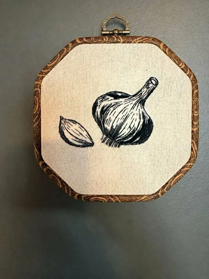 Minimalist black and white sketch style embroidery projects depicting garlic bulb and clove