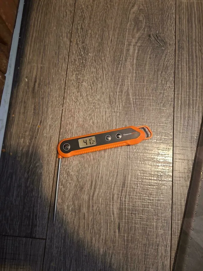 A digital thermometer displaying a high temperature, symbolizing potential Airbnb blunders and the desire for a hotel.