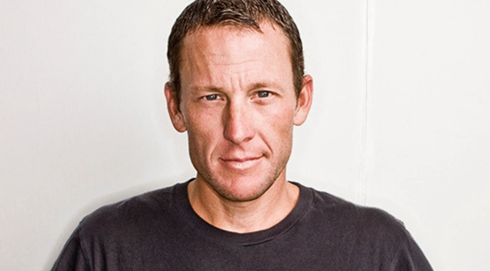 A man wearing a black shirt, representing the 2000s Pop Culture Fill-In-The-Blank and cancer research bracelets.
