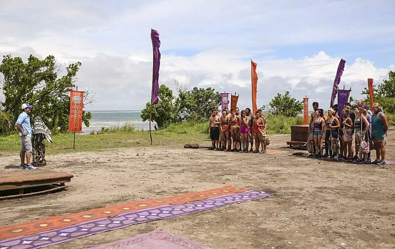 Contestants gathered on a beach for the hit reality TV show Survivor, a 2000s Pop Culture Fill-In-The-Blank.