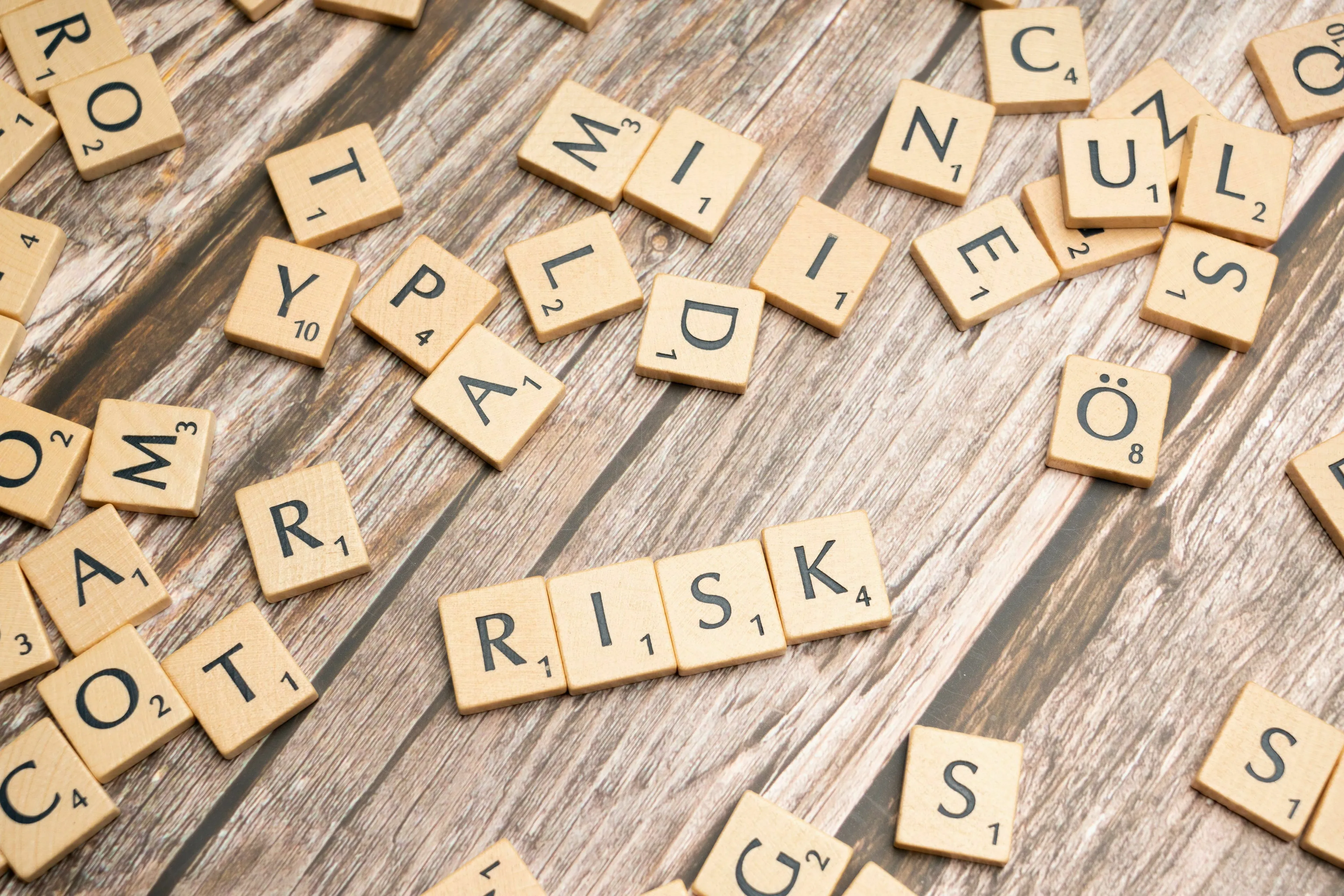 Scrabble tiles spelling RISK, symbolizing the biggest risk in an ancient Roman job.