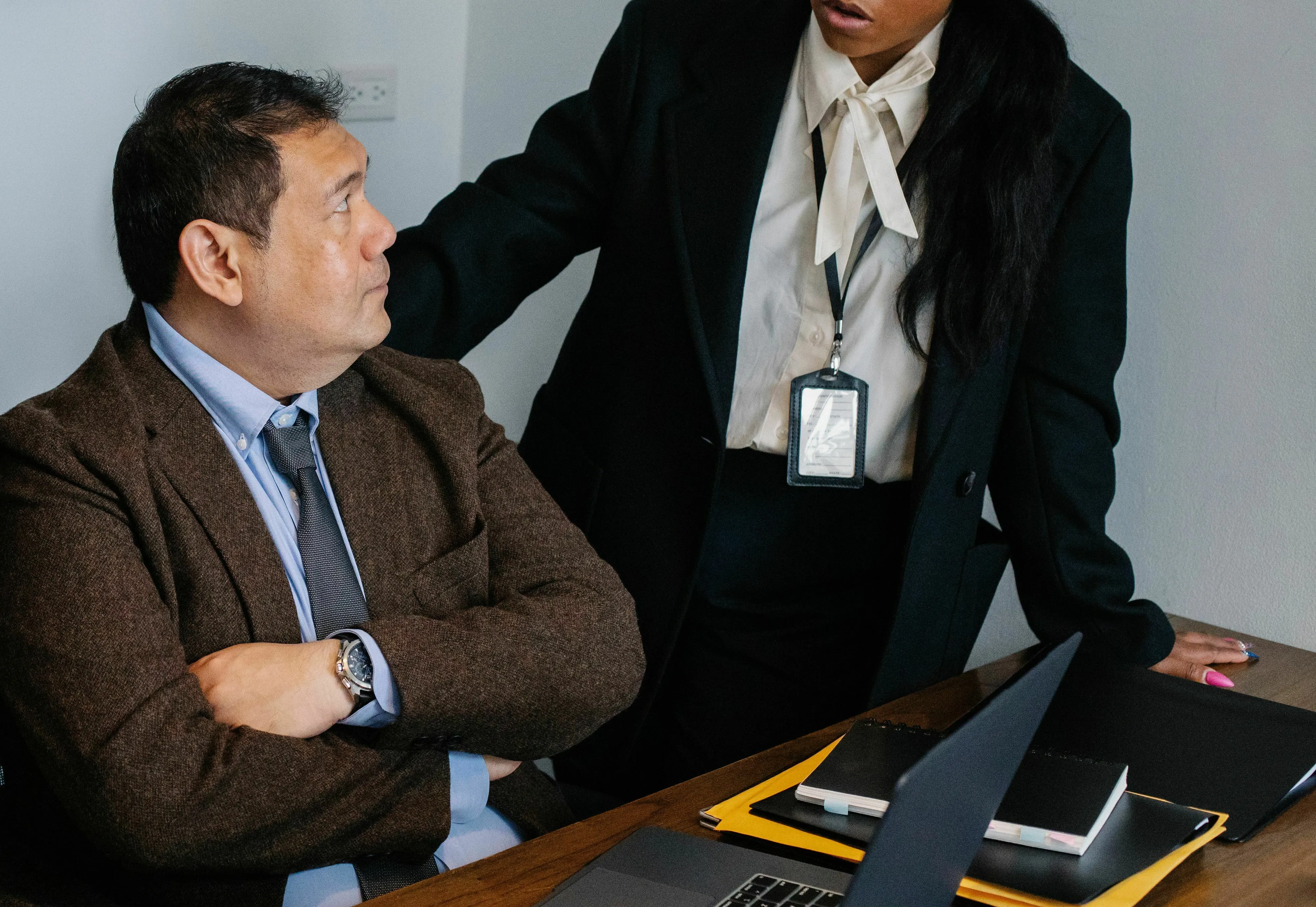 A woman challenges a man's authority in an office, discussing their jobs in Ancient Rome.
