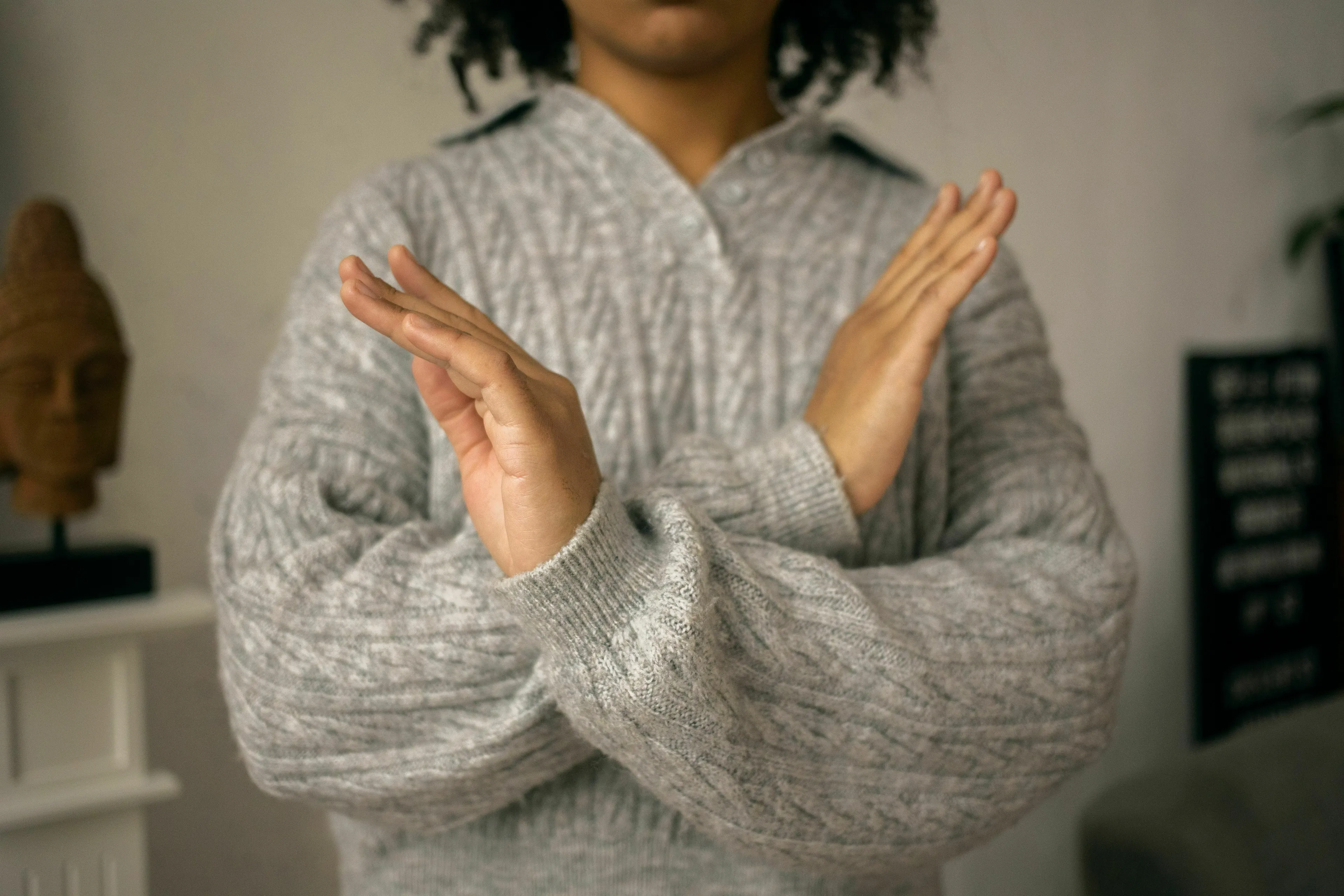 A person crosses their arms in a gesture of dislike, representing what they can't stand about Ancient Rome jobs.