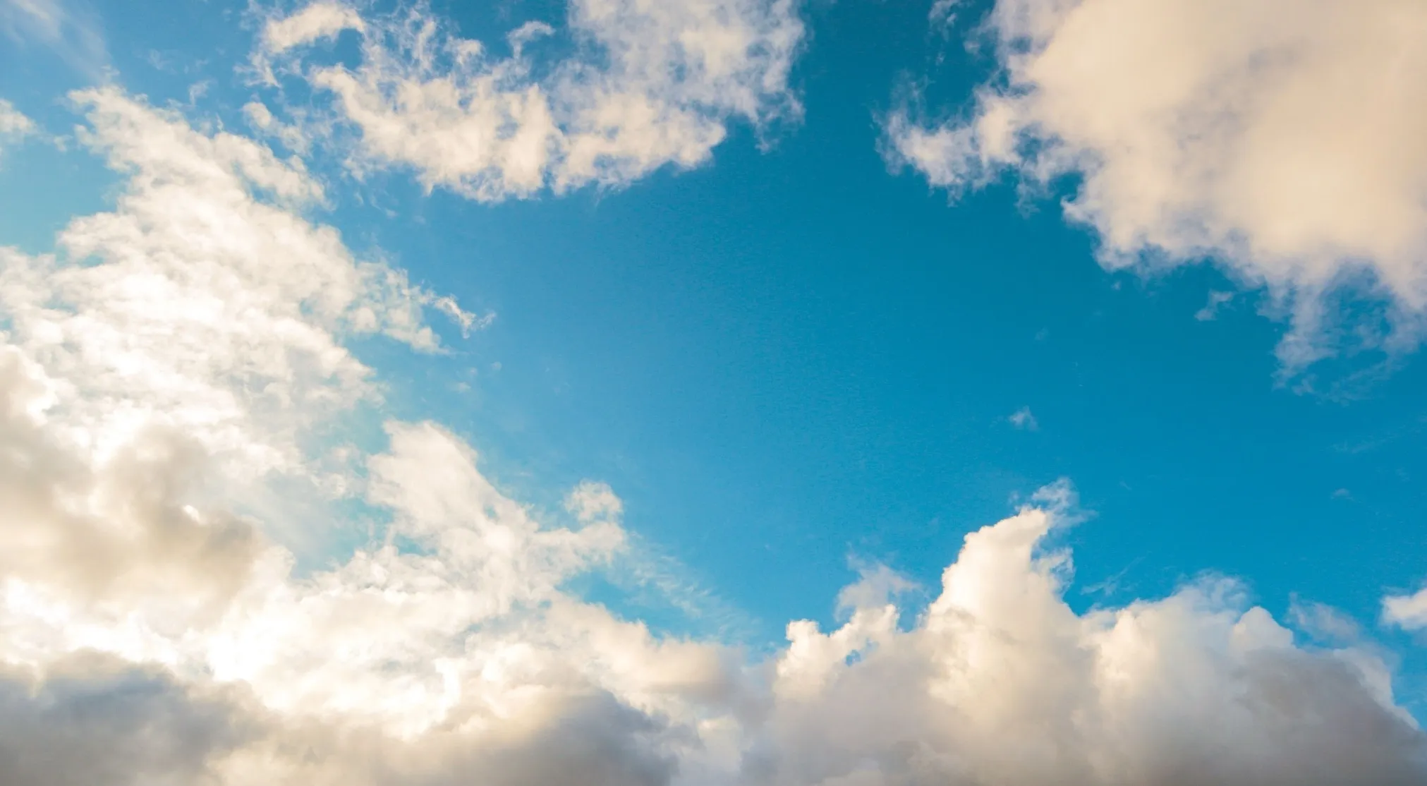 Beautiful clear blue sky with white clouds, highlighting why the sky is blue and other useless facts.