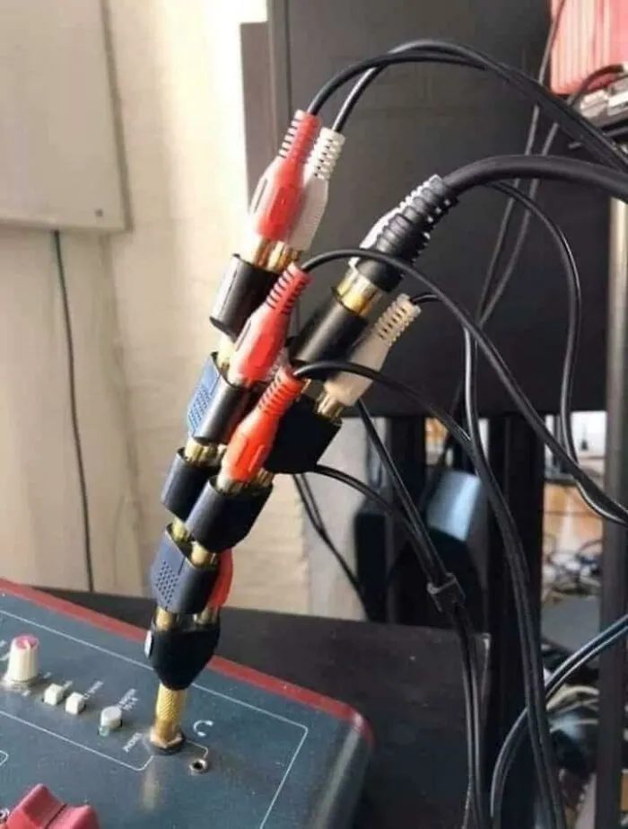 A tangle of red, white, and black audio cables, showing an unhinged way to fix connectivity.