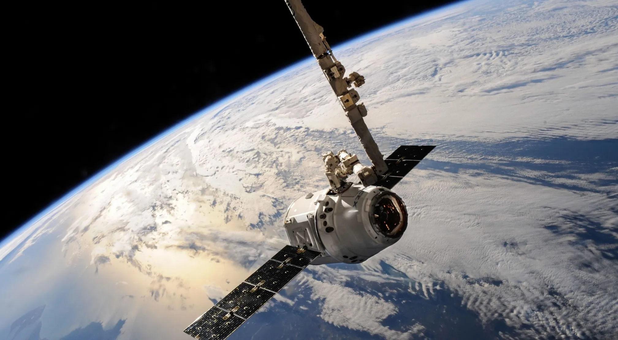 A satellite orbiting Earth, showcasing Physics principles. The image captures the vastness of space and our planet.