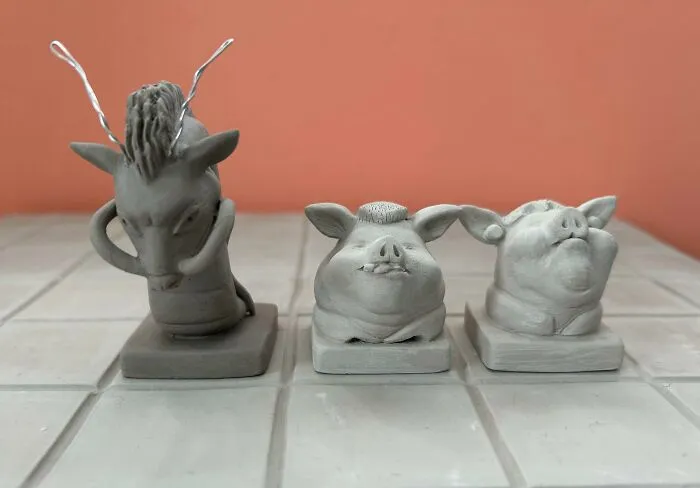 Three small, detailed animal busts made from clay, representing amazing 3D printing creations.
