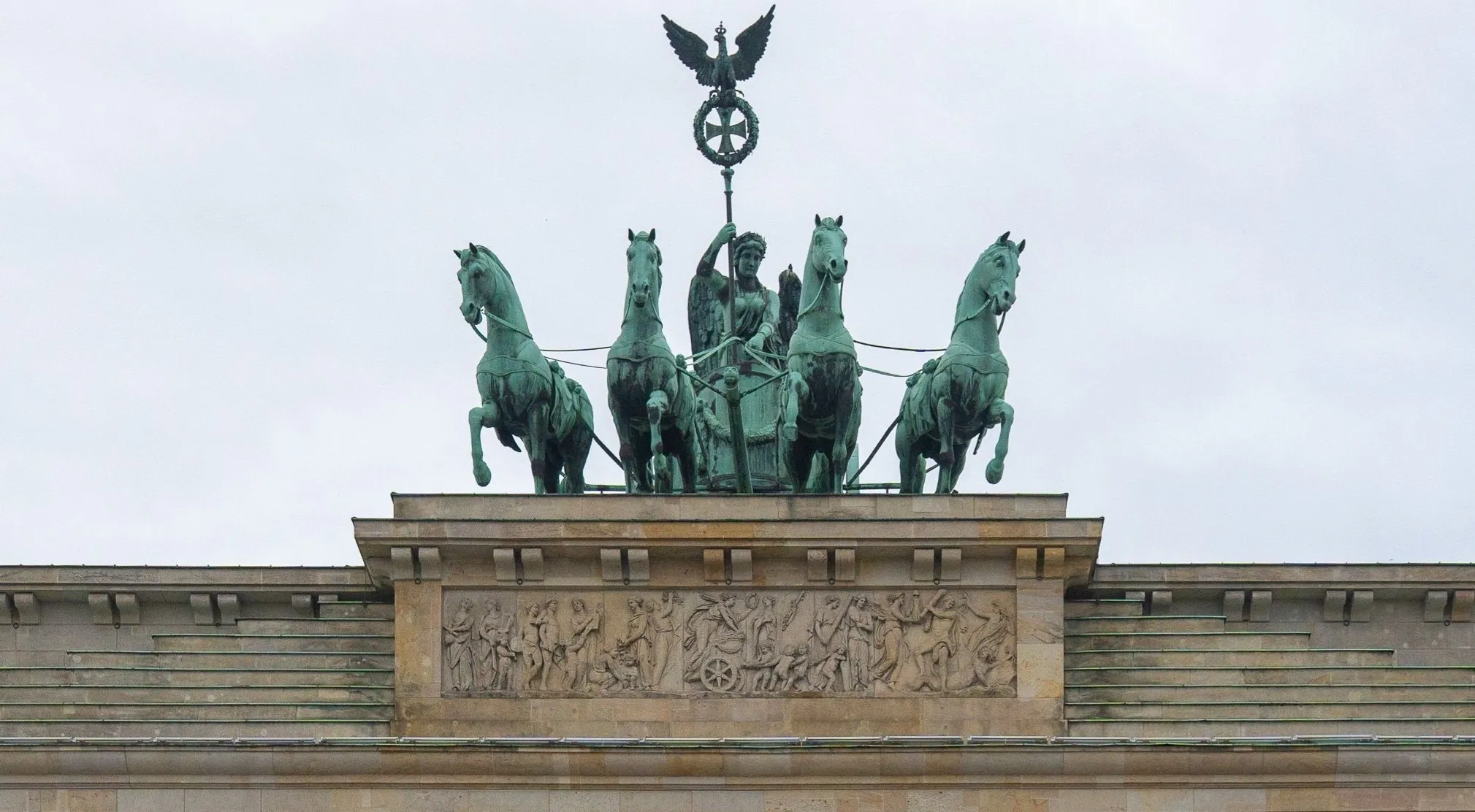 A zoomed in close-up of a famous landmark, the Quadriga statue atop the Brandenburg Gate in Berlin.