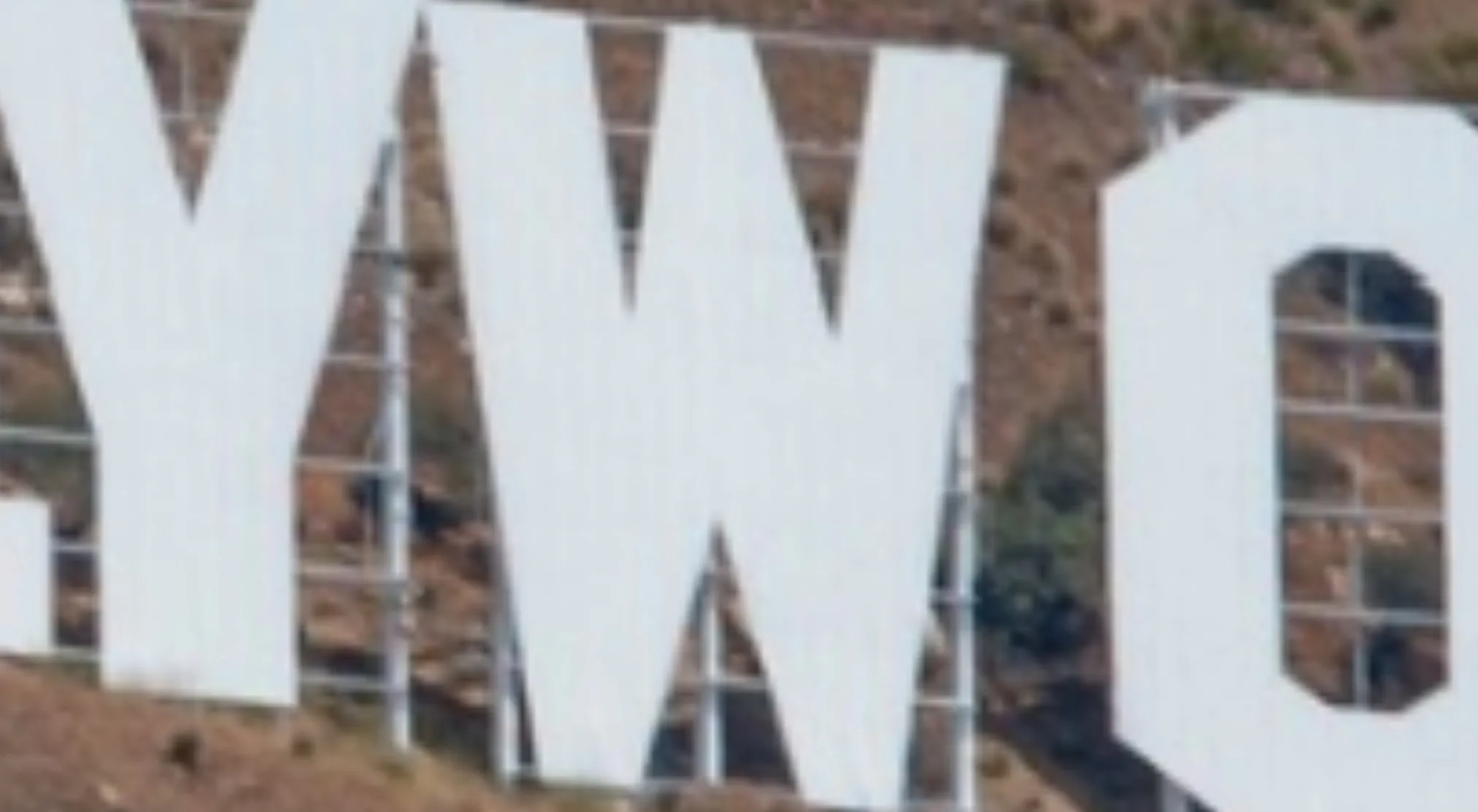 A close-up of the Hollywood sign with white letters against a brown hill; guess the landmark from this zoomed-in image.