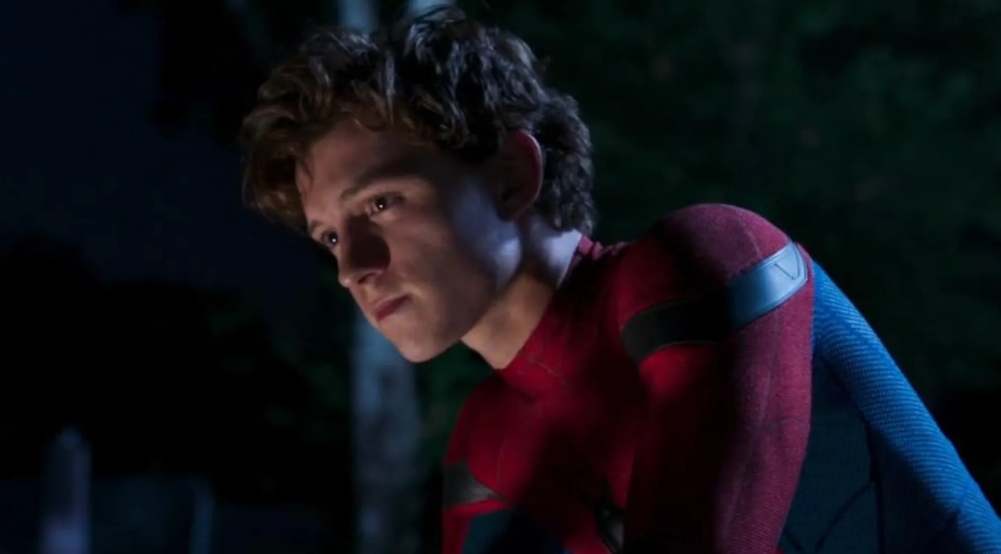 Spider-Man, played by Tom Holland, looking intently to the side, from a movie franchises.