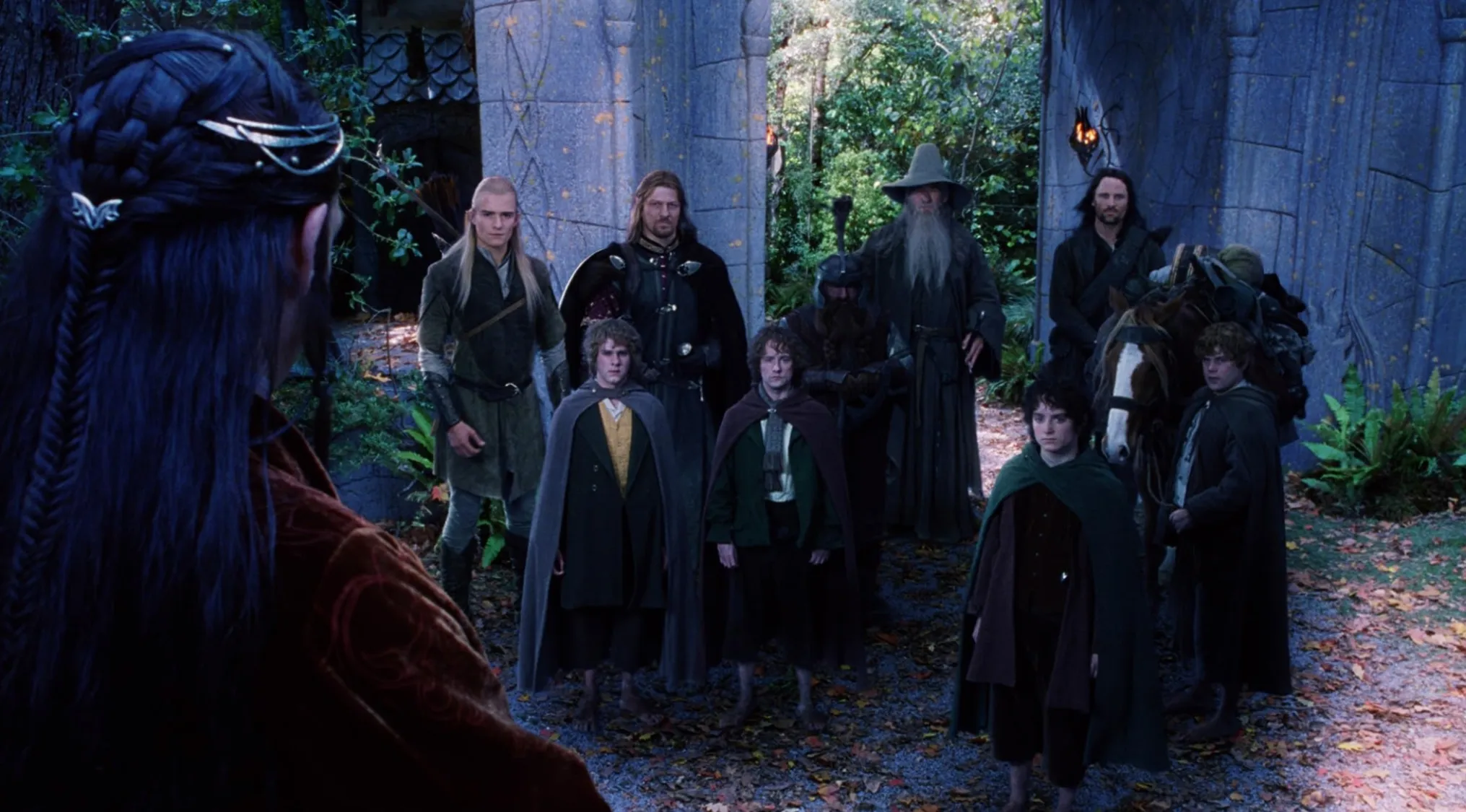 Gandalf, Elrond, and other Lord of the Rings movie franchises characters in an outdoor scene.
