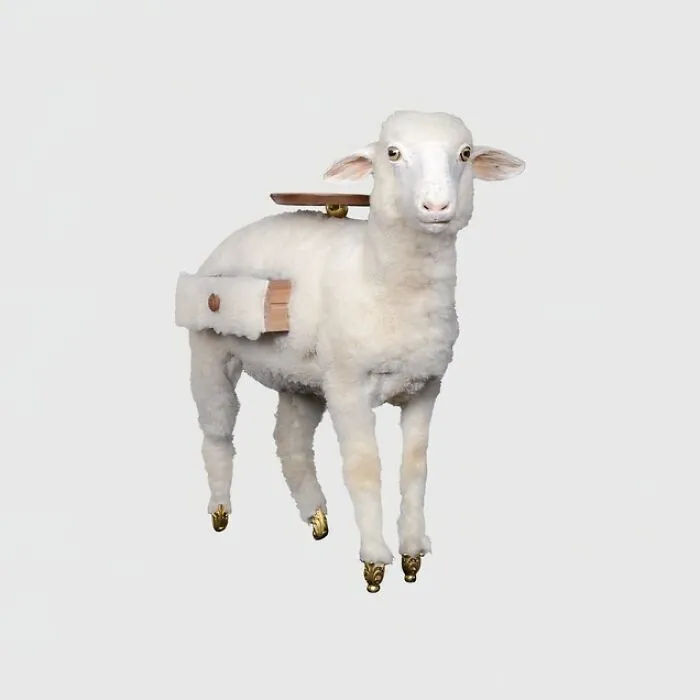 A bizarre furniture design of a sheep with a small wooden table and drawer on its back, standing on golden hooves.