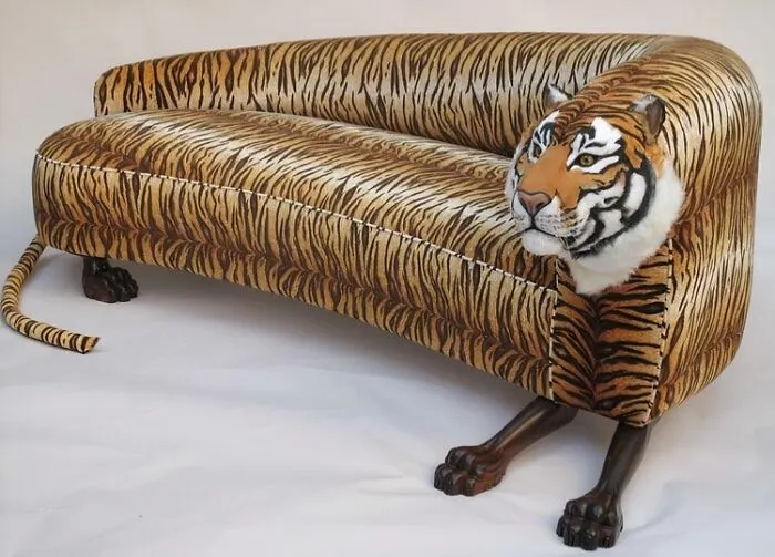 A tiger-themed sofa with a tiger head and paws, one of the bizarre furniture designs.