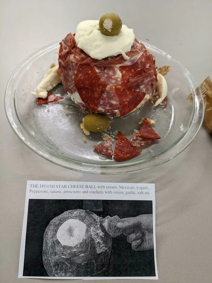 A Death Star cheese ball covered in various meats and toppings, an example of disgusting food.