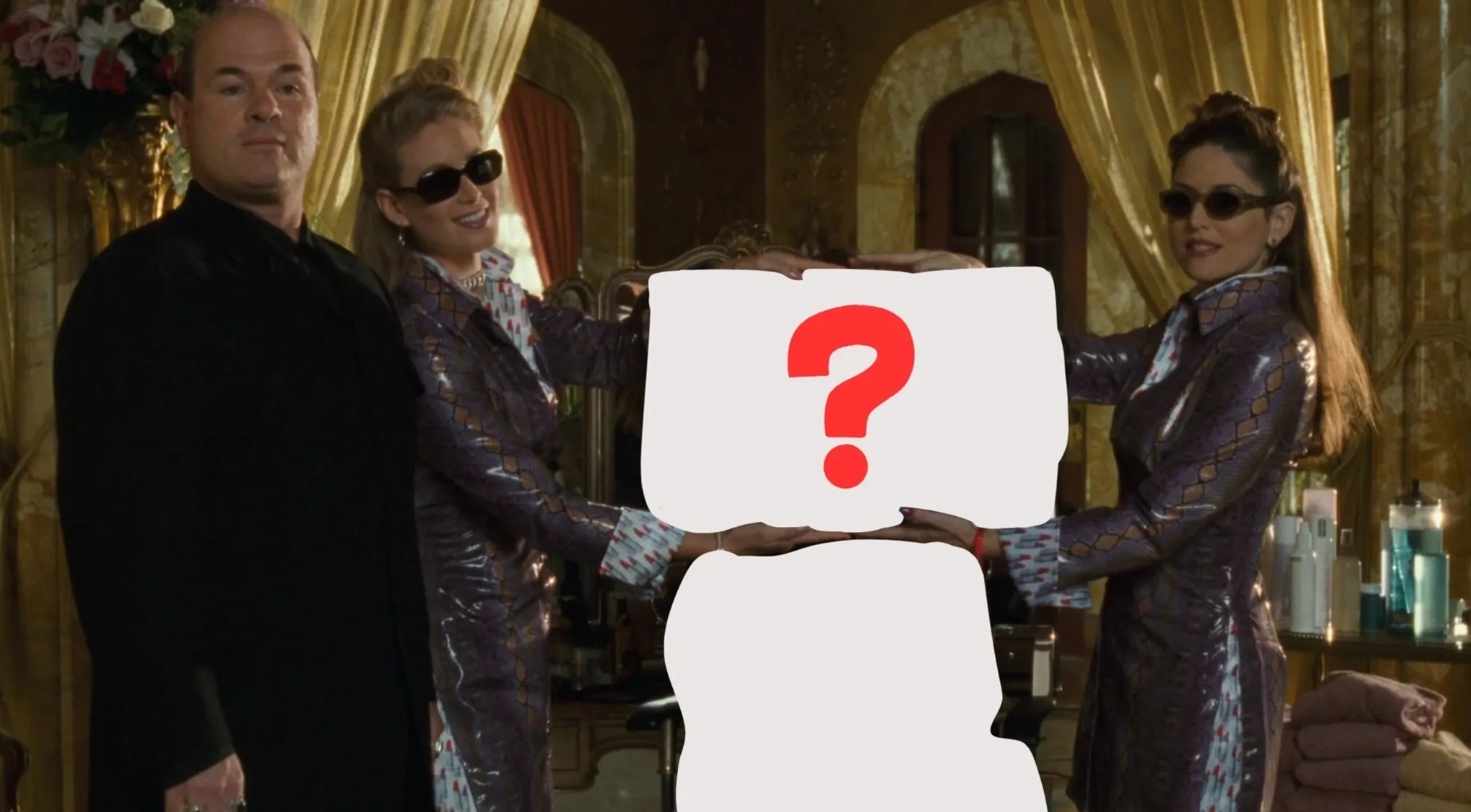 Two women and a man in a Princess Diaries scene. A red question mark hides the missing future queen. Royal life mystery.