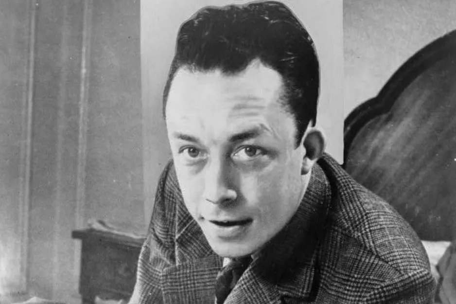 A black and white photo of Albert Camus, an author who won a Nobel Prize in Literature.