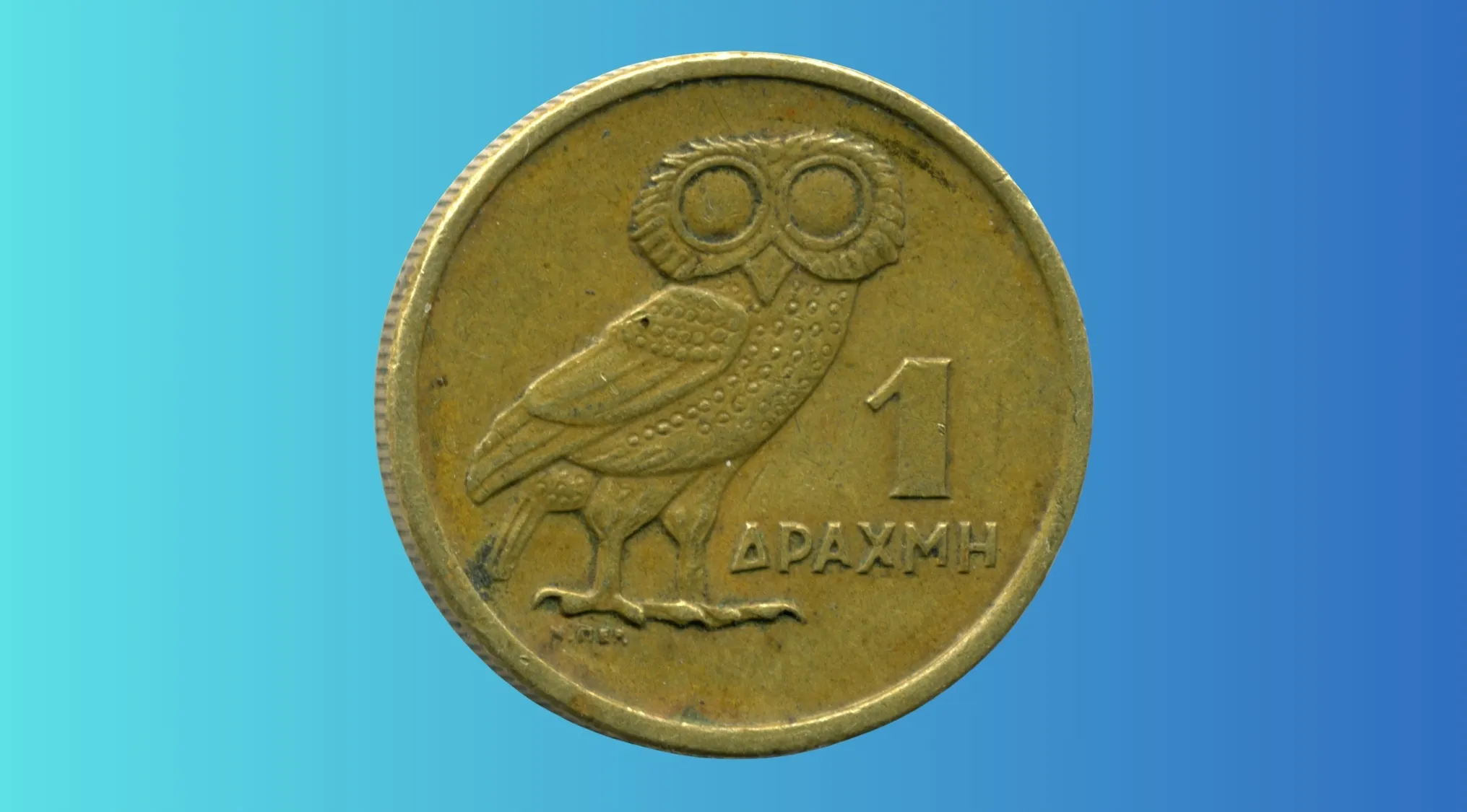 Close-up of a drachma coin featuring an owl, used in European nation before adopting the euro.