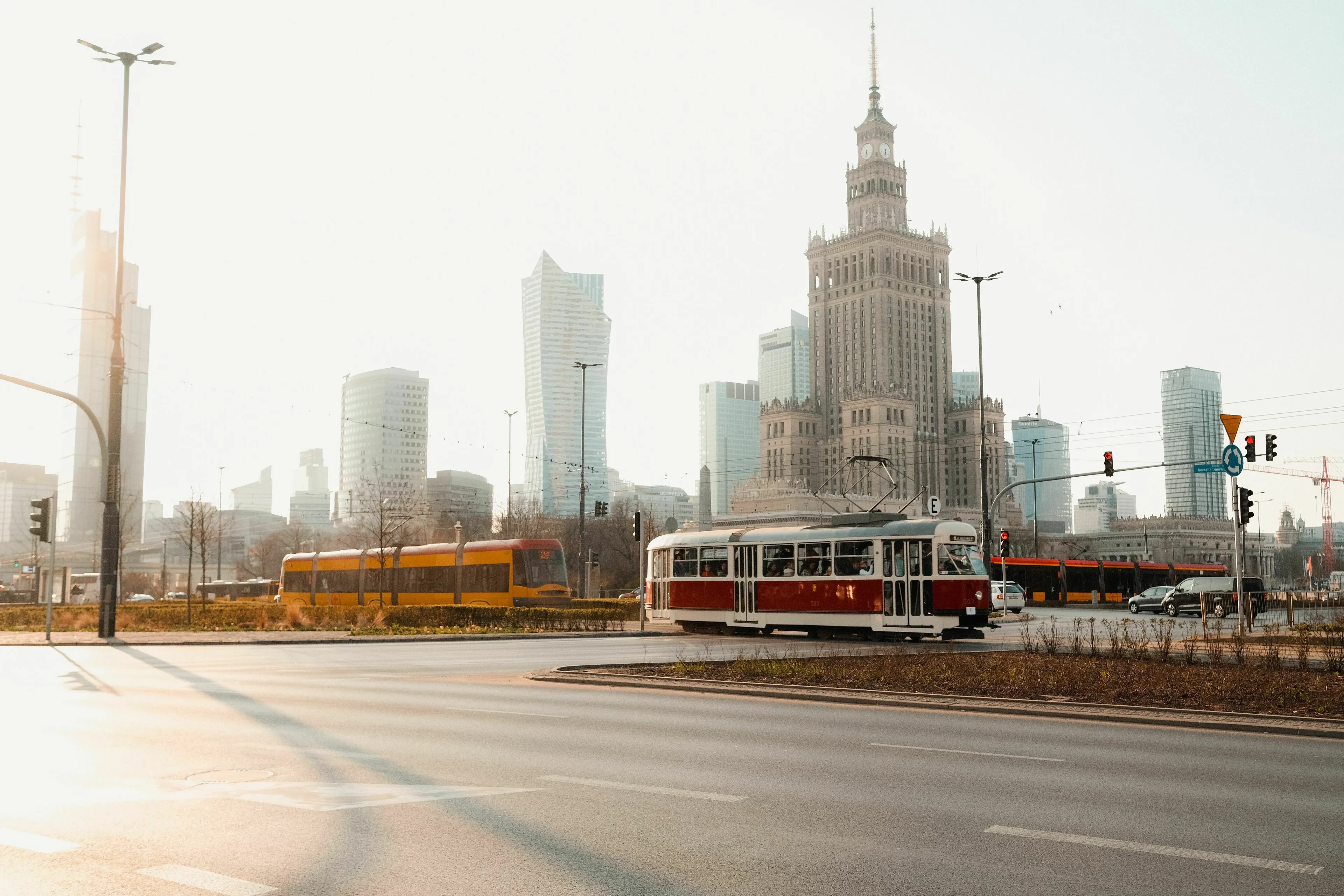 A vibrant city with trams and tall buildings, representing a mode of transport for an unresolved mystery.