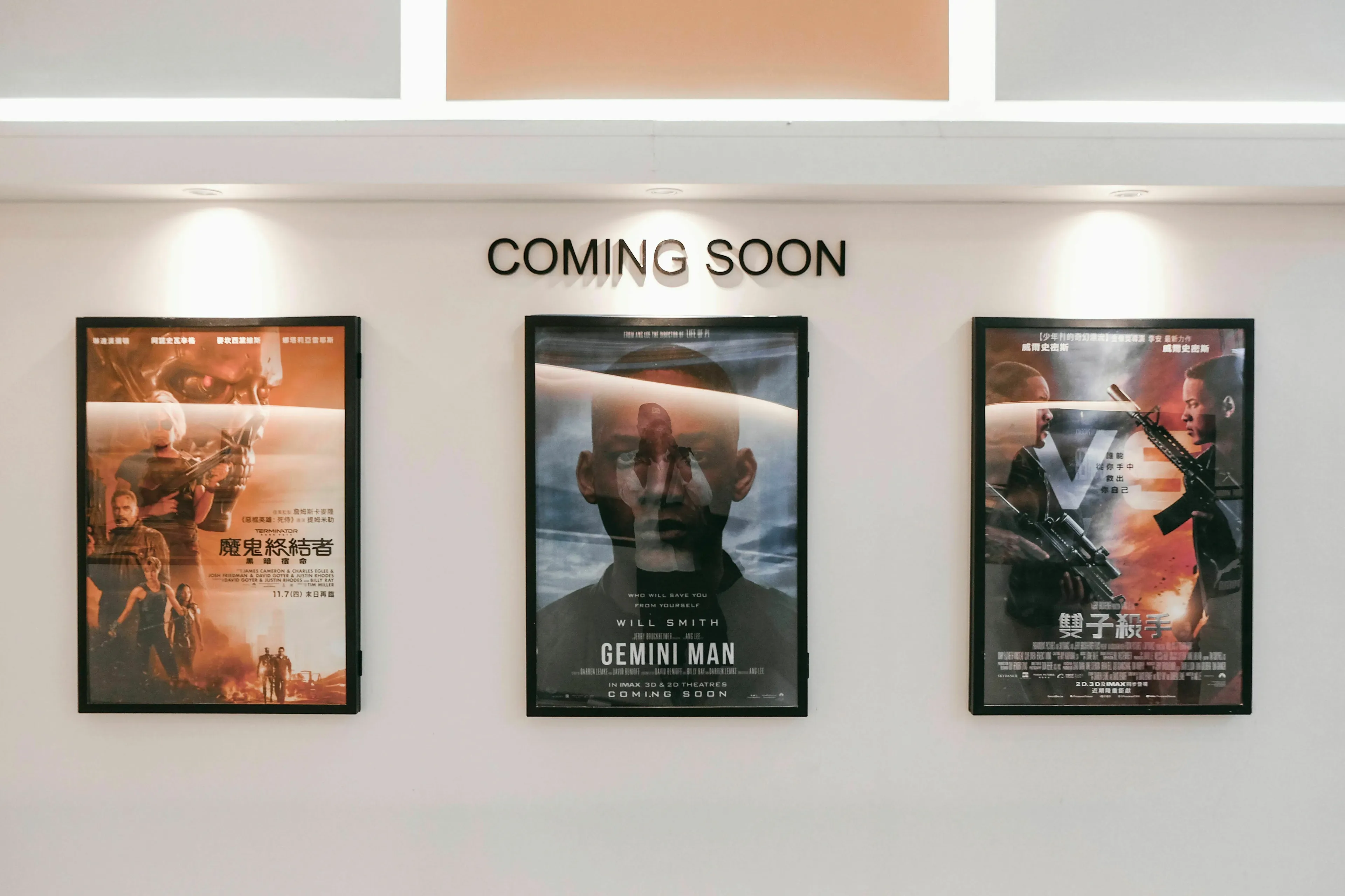 Movie posters on a wall, representing a director shaping a movie villain's origin story.