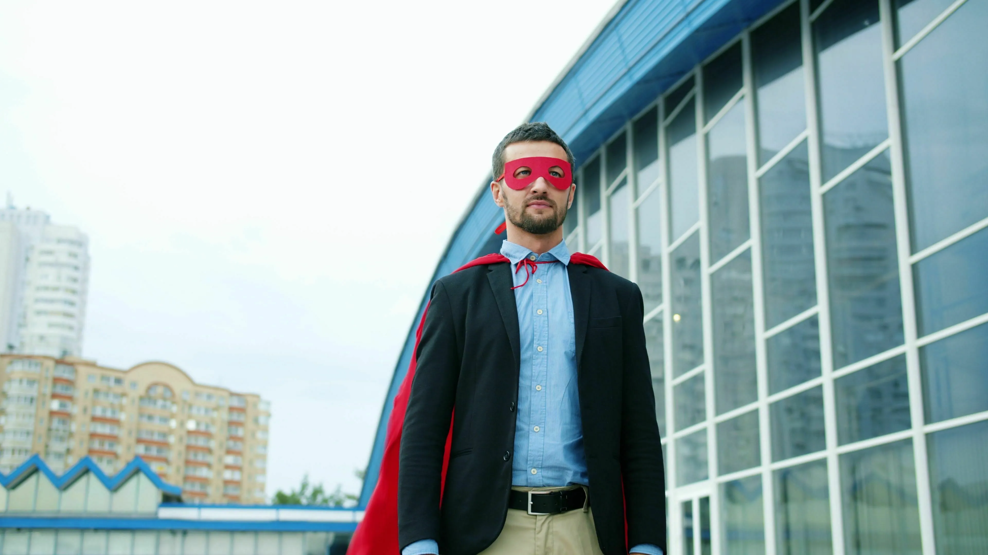 Movie villain in a red mask and cape. This villain is getting close to the hero.