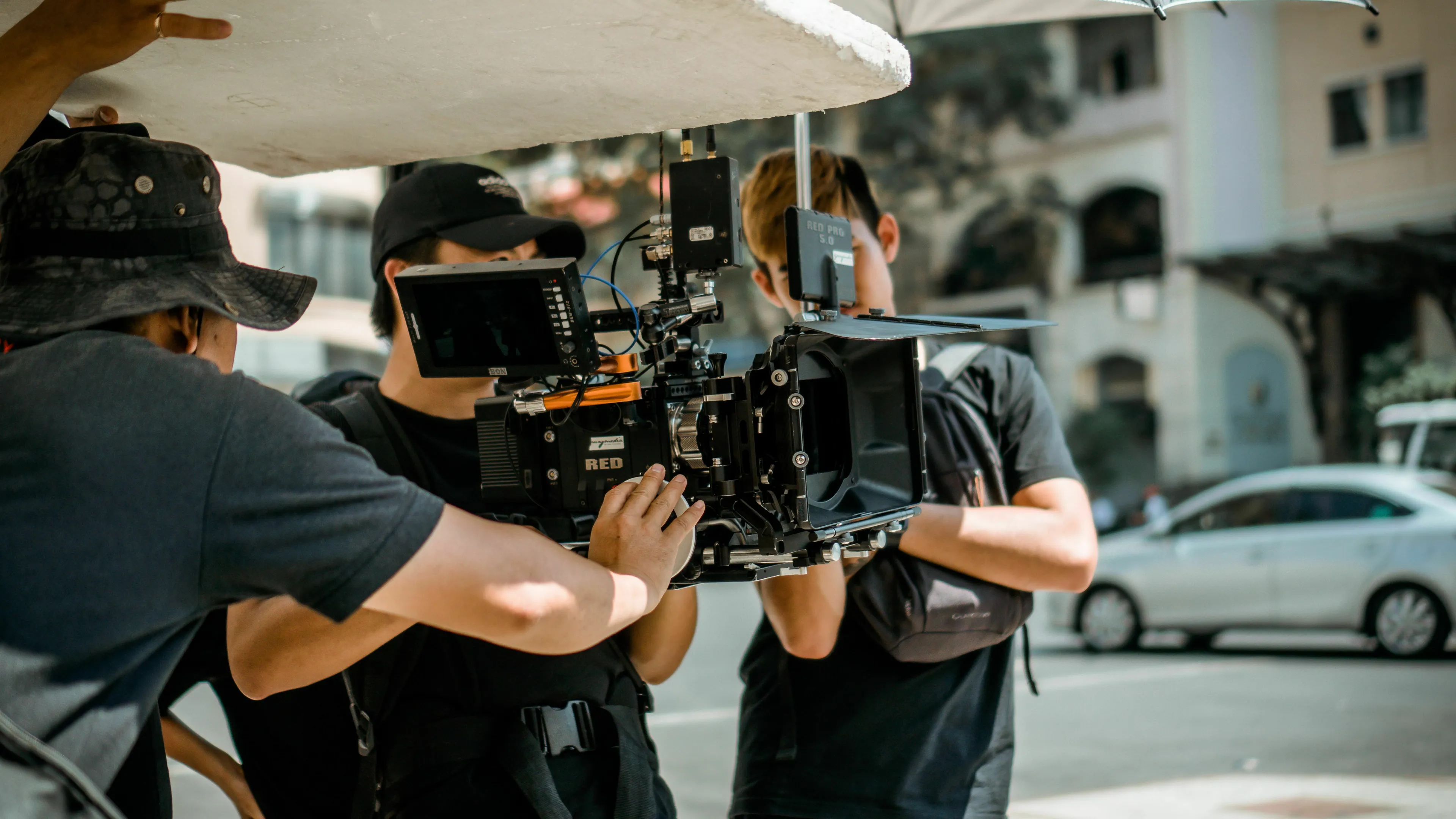 A camera crew filming a movie villain on set, a camera lingers on the actor's face.