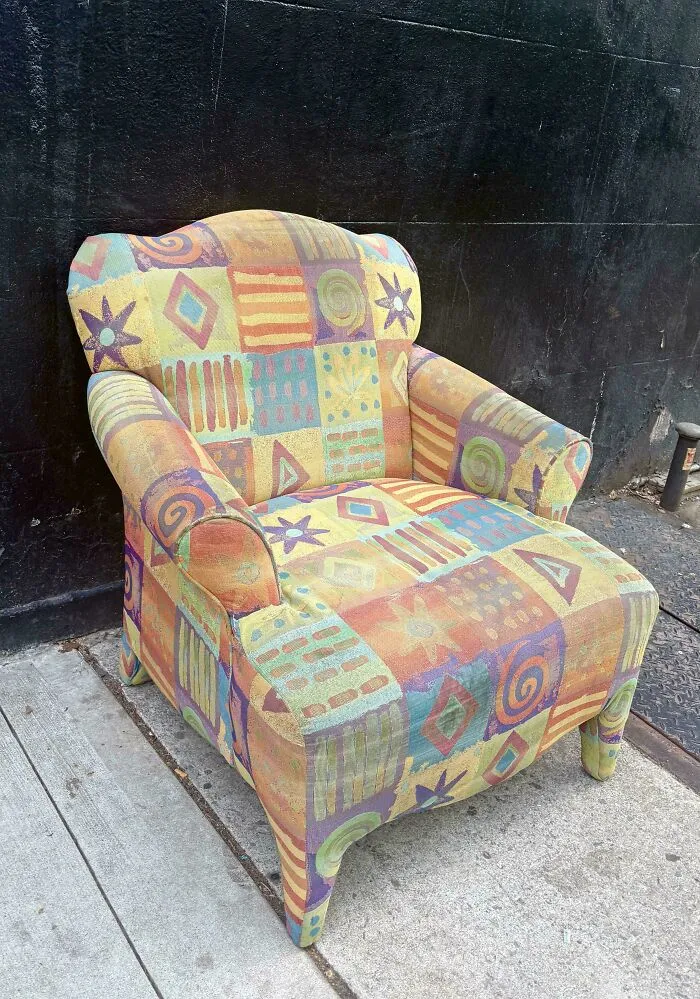 A vibrant, patterned armchair with a patchwork design, reflecting the unique style of the 90s.