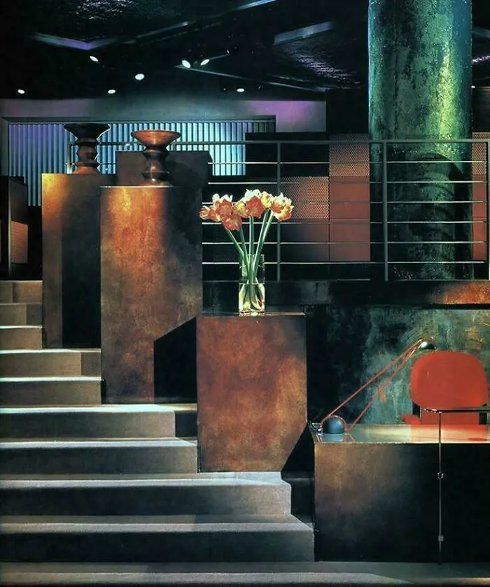An interior with dramatic lighting and geometric structures, showcasing 90s design aesthetics.