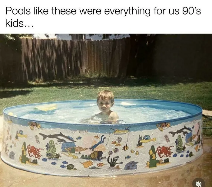 A young boy smiling in a small, round inflatable pool, depicting life in the 90s.