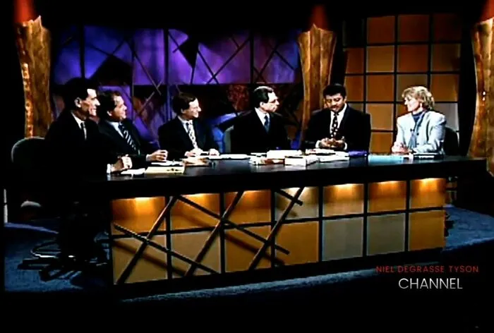 A panel of people on a TV set discussing 90s life and pop culture.