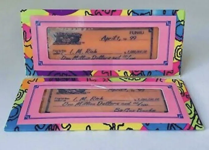 A colorful toy checkbook for life in the 90s, featuring a fake million-dollar check in a bright pink frame.