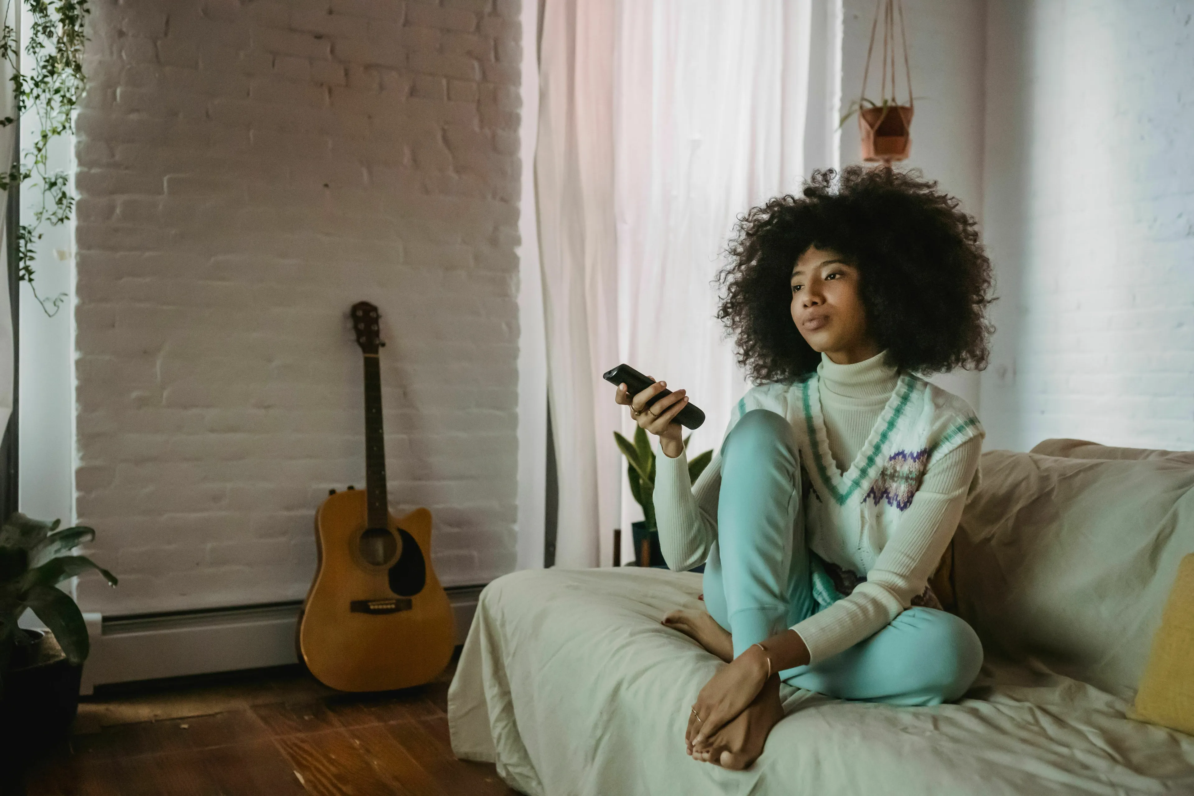Young woman watching a movie on a stressful Friday night, illustrating a stress response.