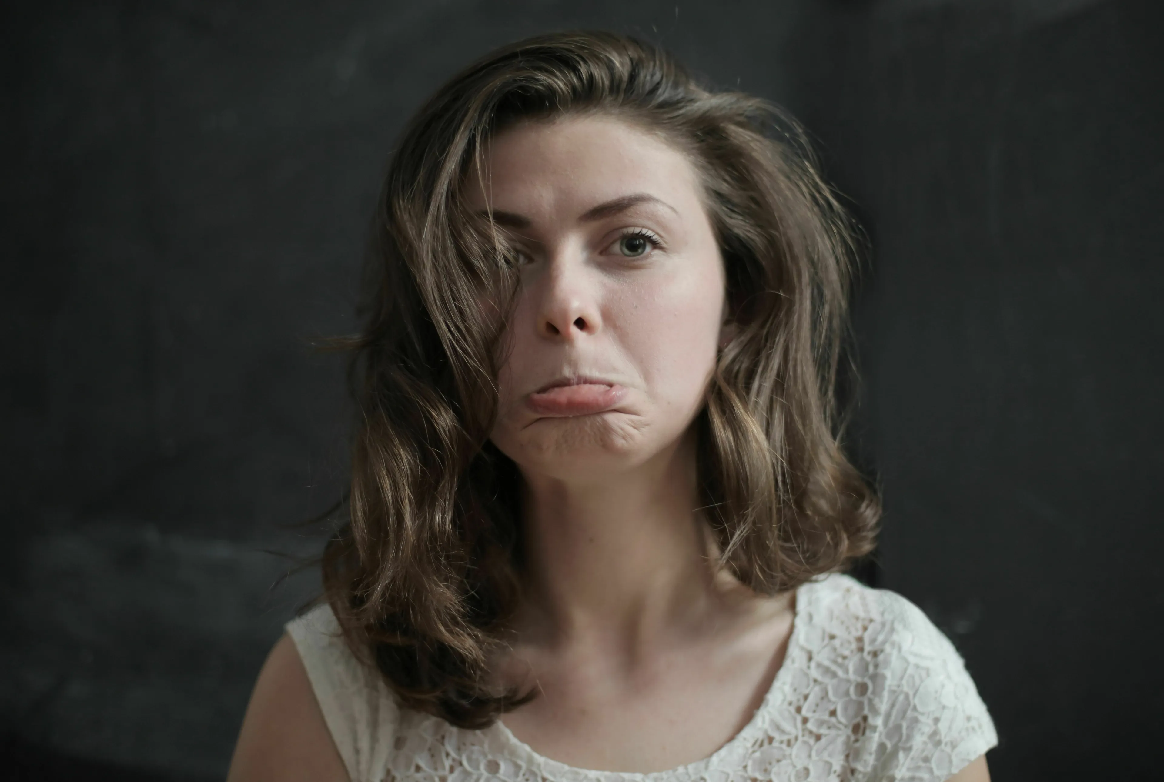 A woman with a sad expression, showing her stress response to cancelled plans.