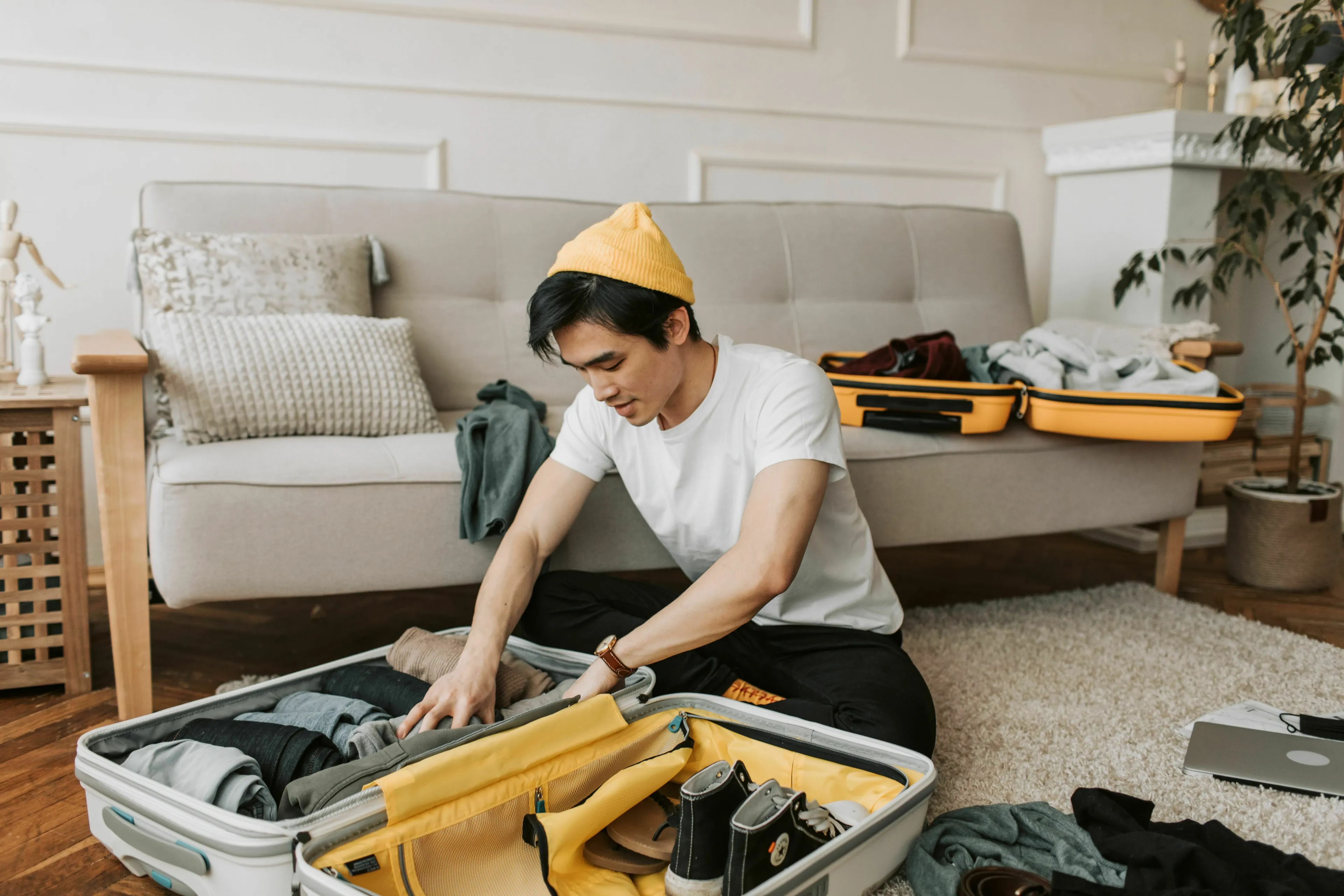 Identify your stress response type: a man packs his suitcase for a trip, folding clothes neatly.