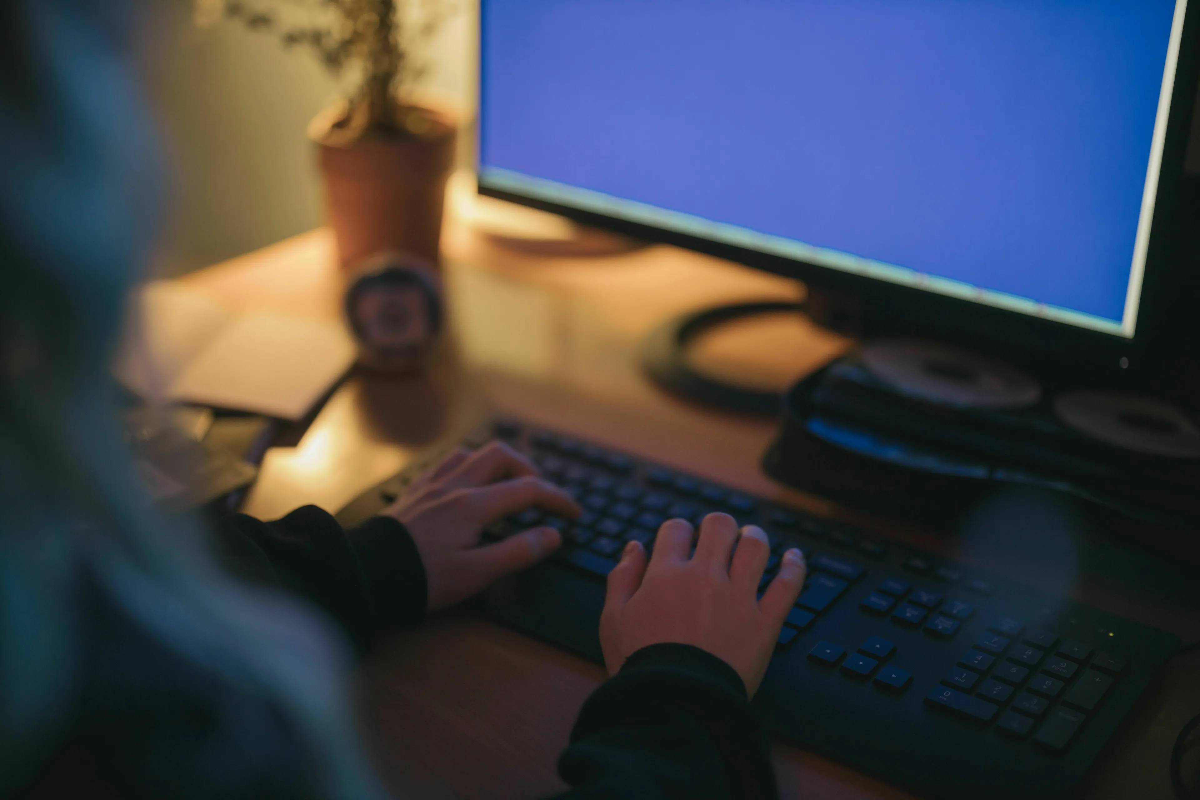 Person looking at a blue computer screen, experiencing a stress response to a computer crash mid-task.
