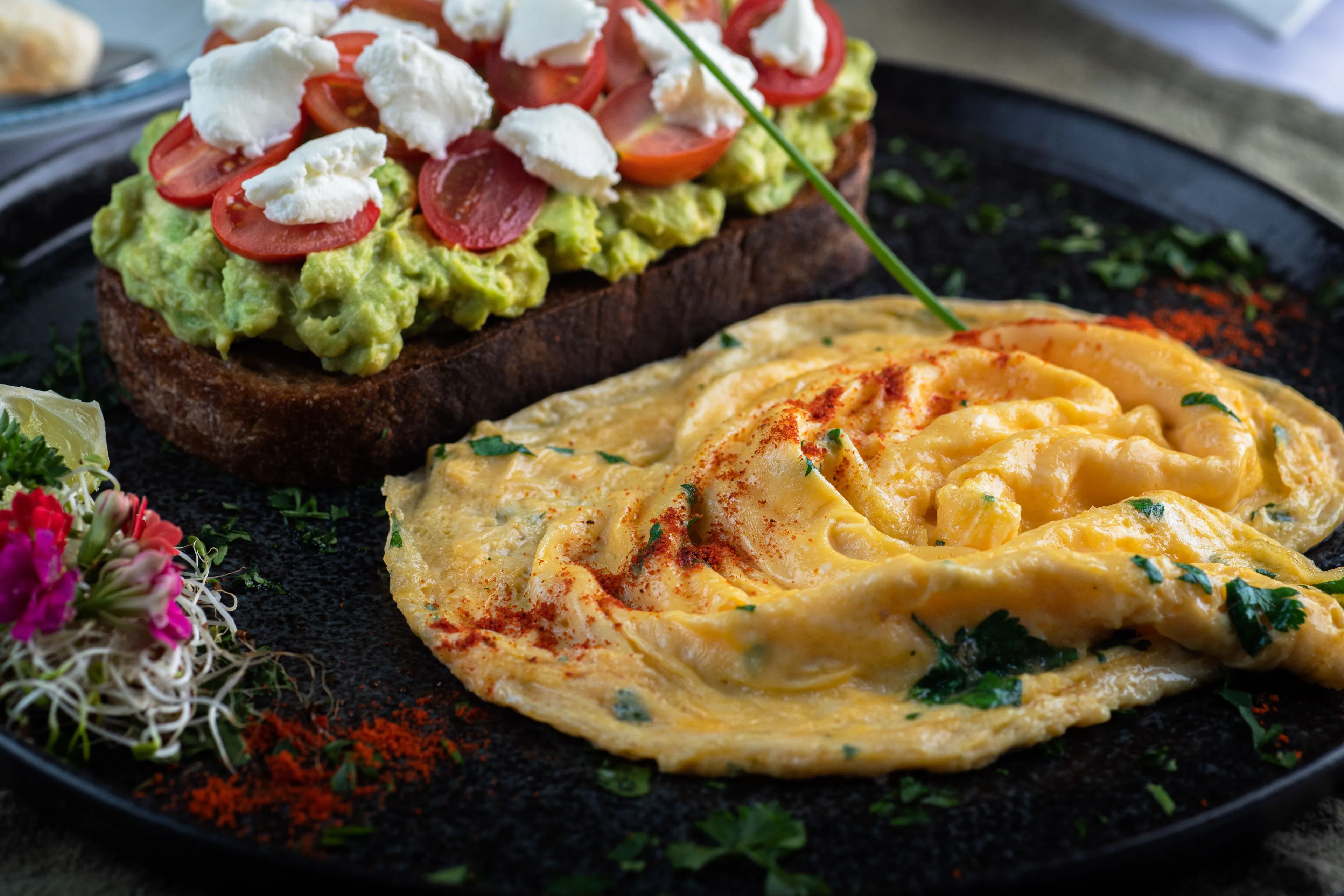 A delicious brunch spread with avocado toast and an omelet, perfect for hosting brunch.