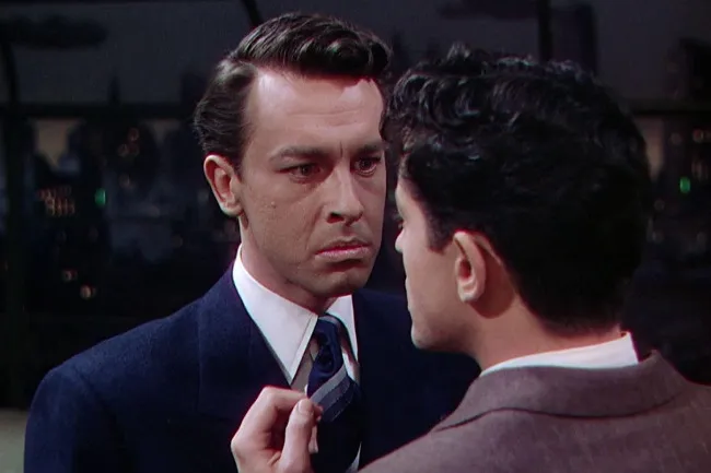 Two men in a tense moment from the Hitchcock film Rope.