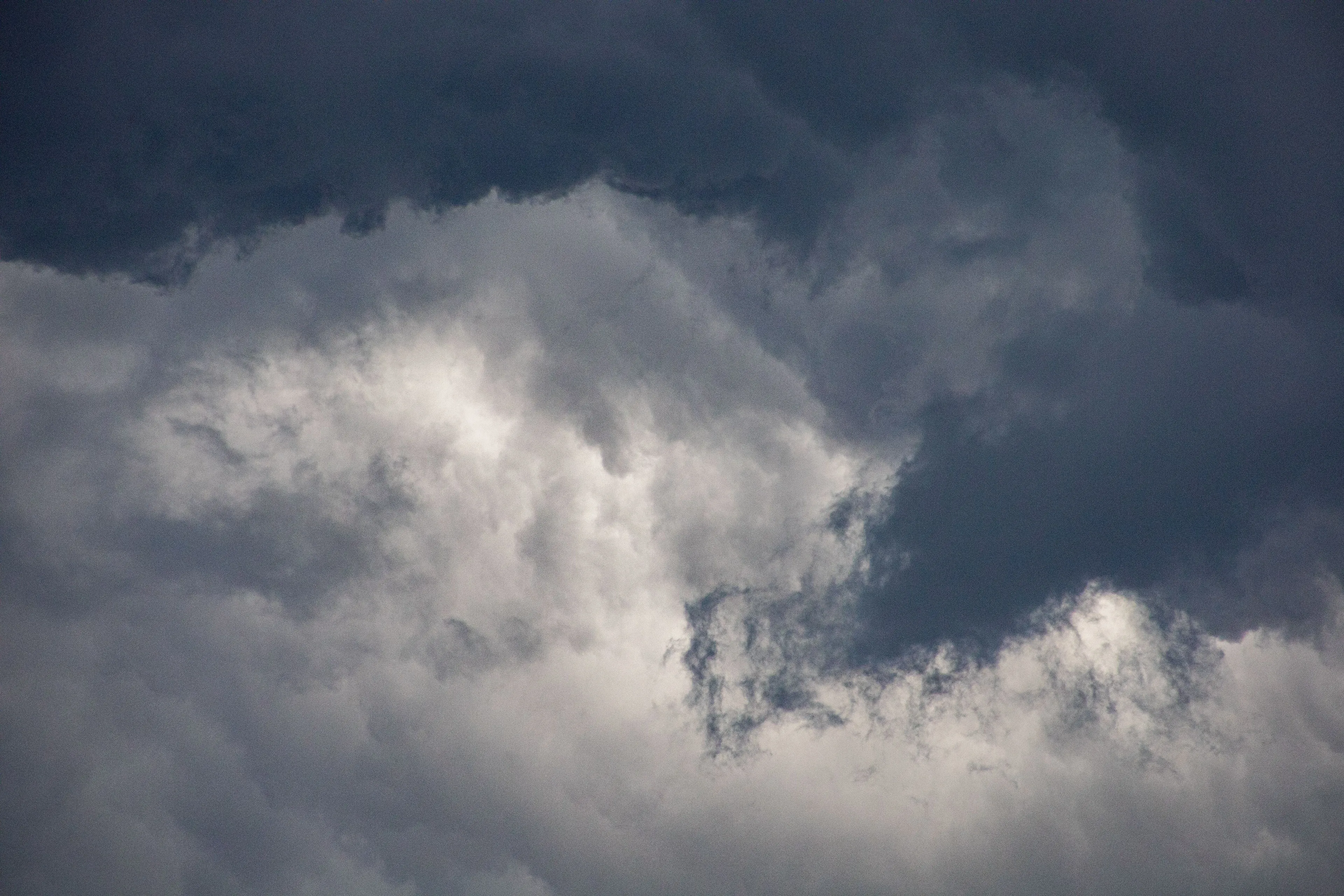 Overcast sky with dark, dramatic clouds.