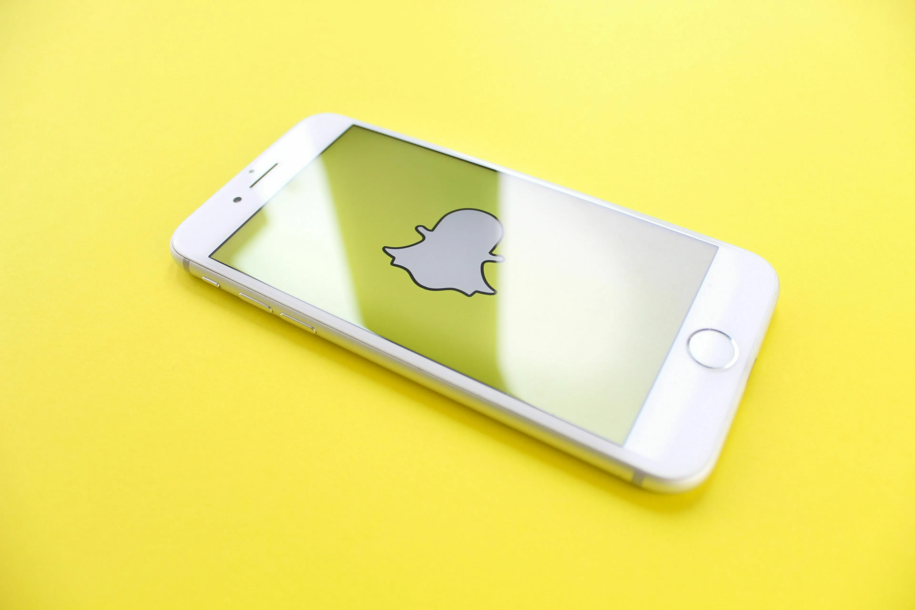 Quiz edition image of a phone displaying the Snapchat logo. The app was originally called Picaboo.