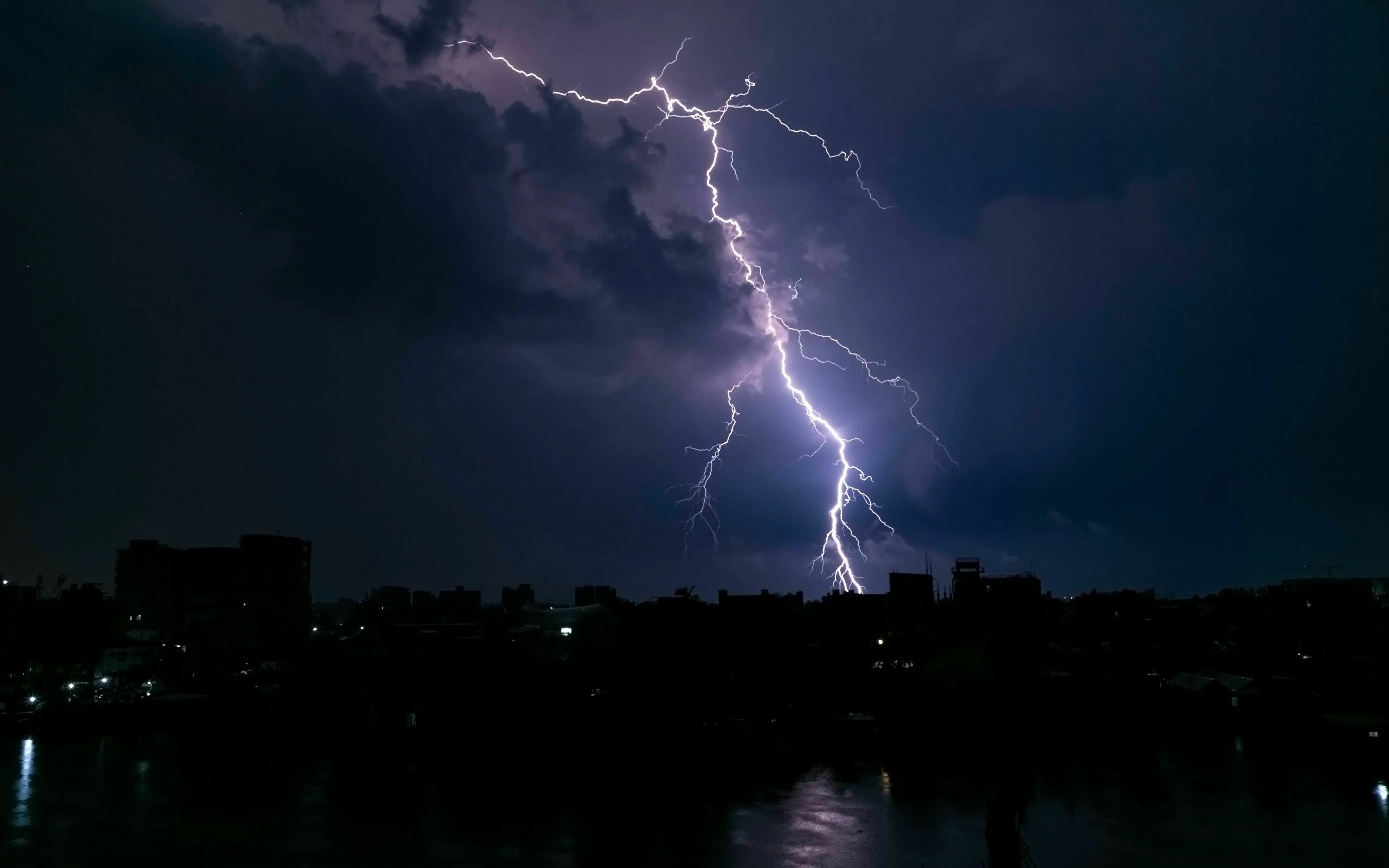 Lightning strikes a cityscape at night, illustrating a common myth for the Real from Fake quiz.
