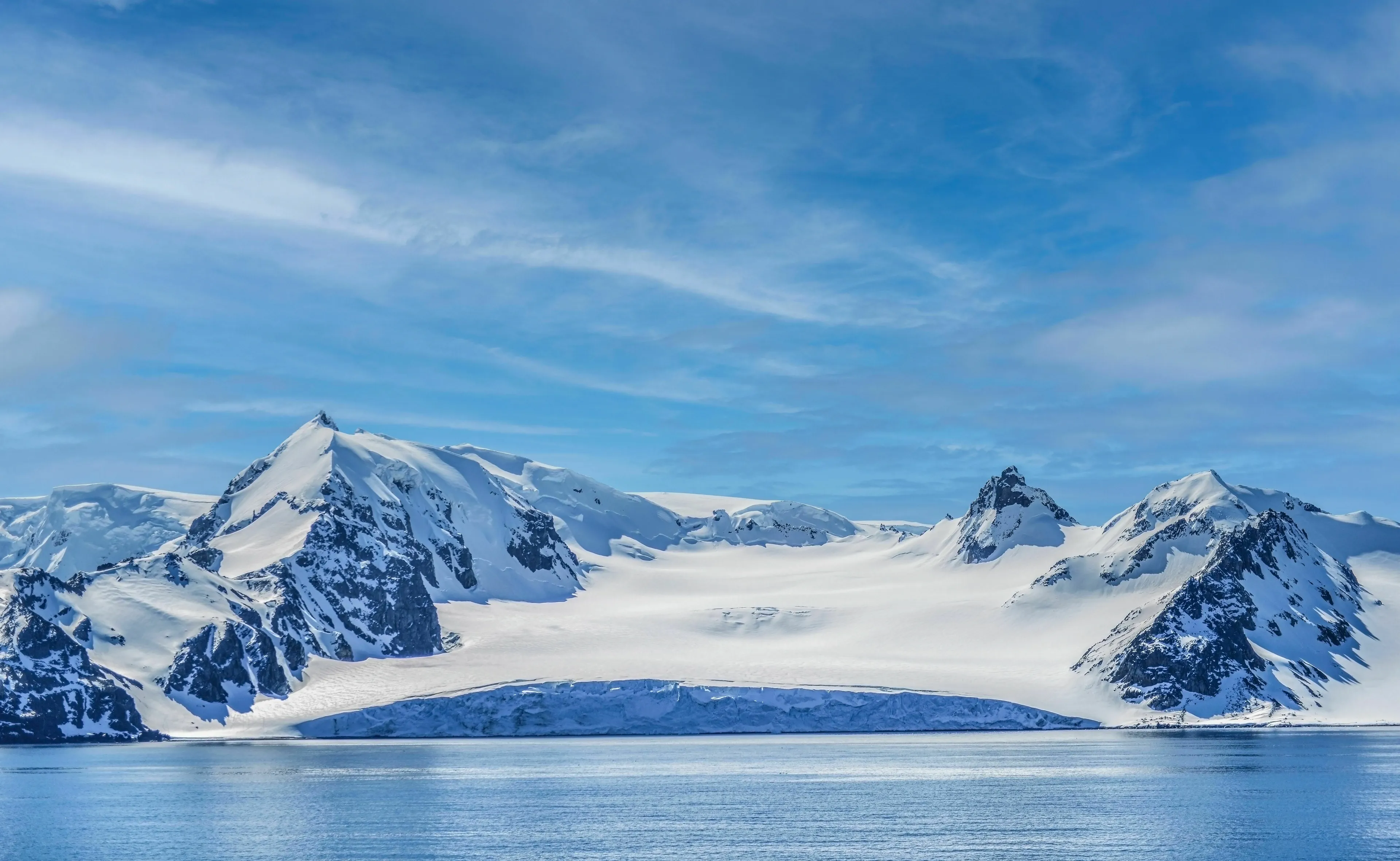 Snow-capped mountains and water in Antarctica, challenging the idea that it is the world's largest desert.
