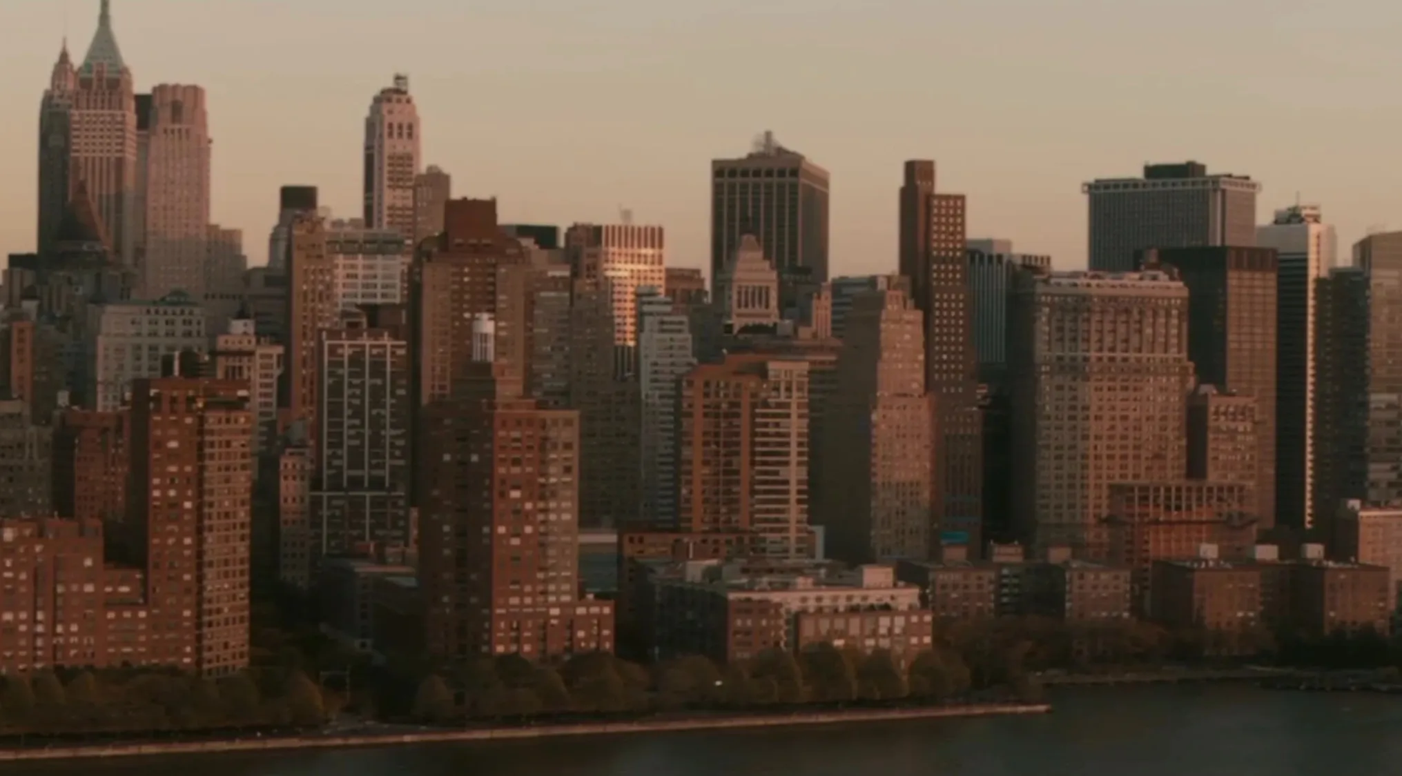 A pub trivia quiz question: Which fictional city is home to Superman? A panoramic view of a large city skyline at dusk.