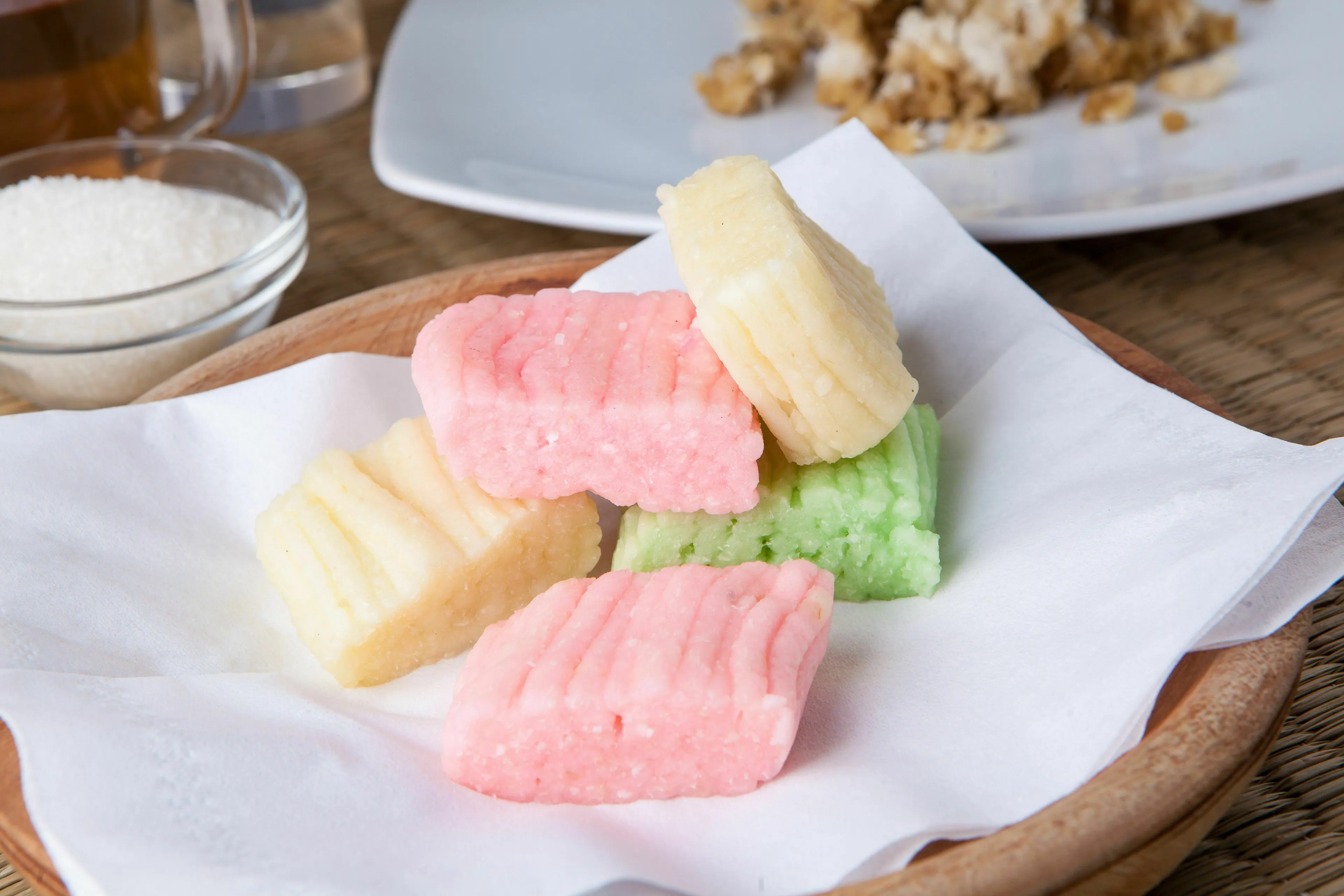 A pub trivia quiz question: Which nut is used to make marzipan? Colorful marzipan candies on a white napkin.